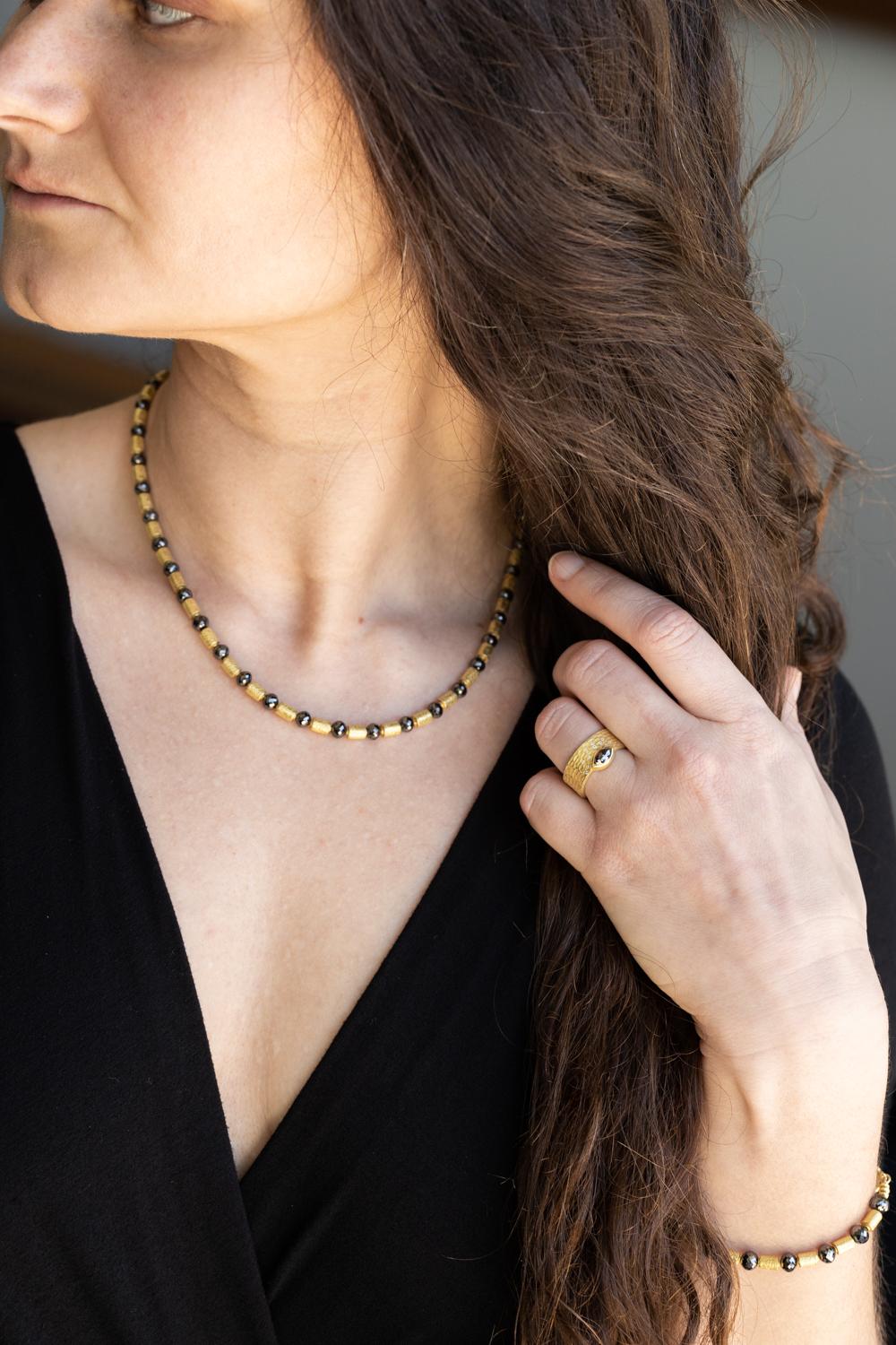 Elevate your jewelry collection with the Glacier Ring, a breathtaking piece featuring a striking black rose cut diamond (0.51ctw) surrounded by surface-set diamonds (0.07ctw) in radiant 18k yellow gold. This exquisite ring, sized at 6.25, combines