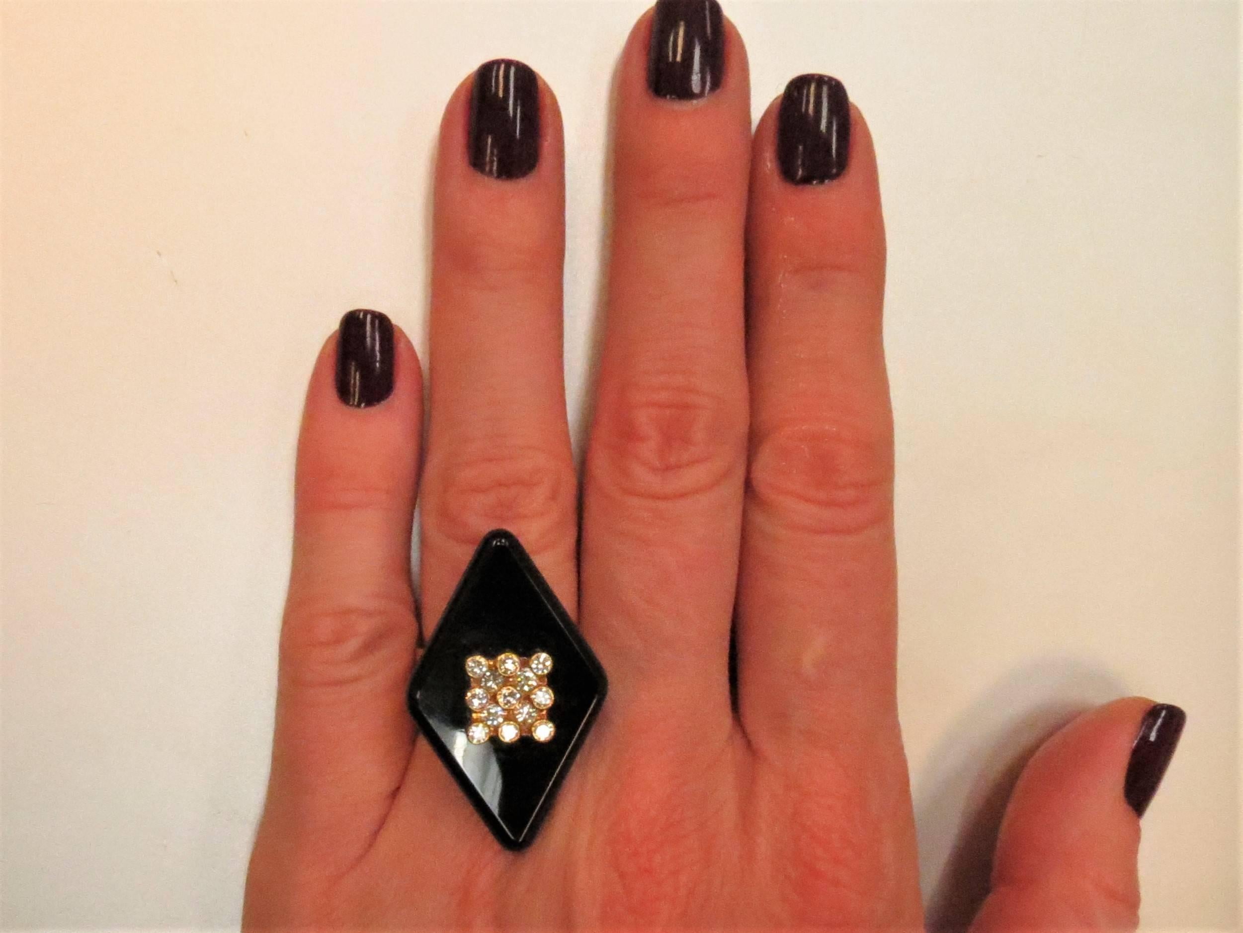 Iconic French Designer, Weisager,  18K yellow gold ring with diamond shape black onyx and 13 bezel set full cut round diamonds weighing .60cts, G-H color, VS clarity
Finger size 6, may be sized