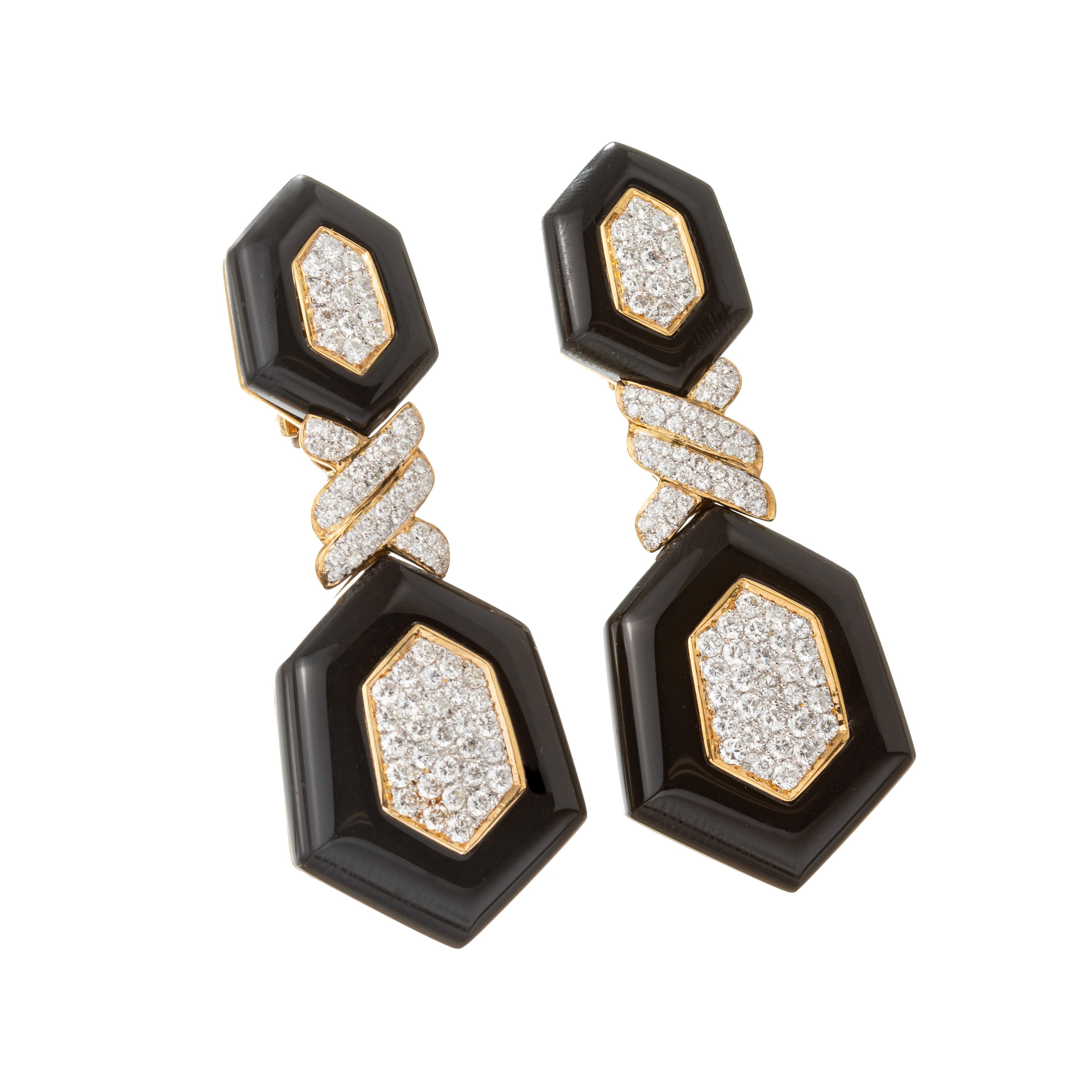 1970s statement drop earrings in 18k yellow gold, built in the Art Deco revival style featuring classic geometric patterns adorned in carved black onyx and pave-set colorless diamonds.

168 round brilliant-cut diamonds weighing approximately 5.04