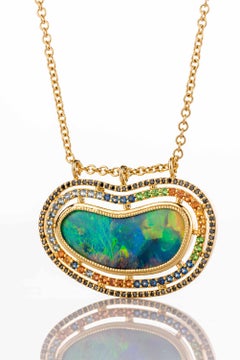 18 Karat Yellow Gold Black Opal Necklace with Diamond, Garnet, and Sapphire Halo