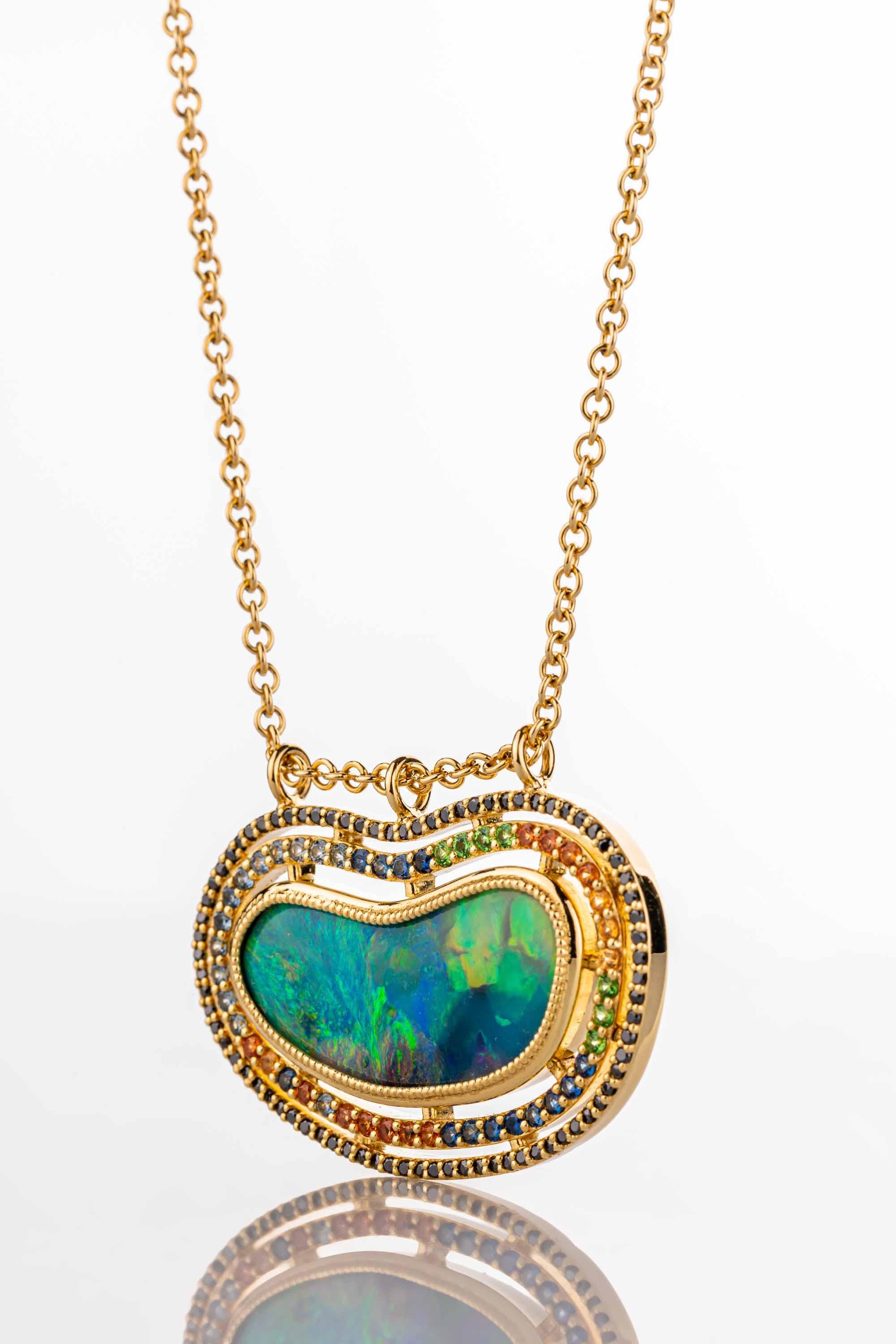 Contemporary 18 Karat Yellow Gold Black Opal Necklace with Diamond, Garnet, and Sapphire Halo