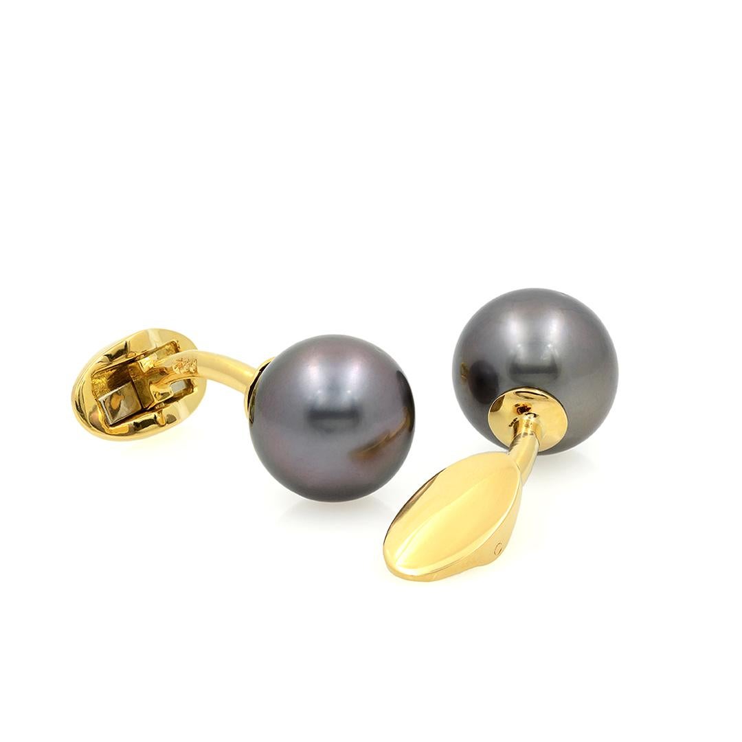 This pair of 18 karat yellow gold cufflinks feature black Southsea cultured pearls each measuring 12.84mm in diameter. 
- 18k Yellow Gold
- Black Southsea Cultured Pearls
- 12.84mm in Diameter
- Circa 1990's