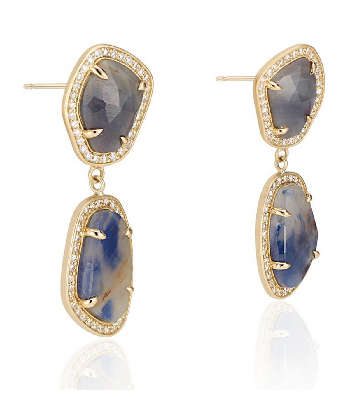 One-of-a-kind sapphire earrings, the wild and raw beauty of these uniquely colored natural sapphires illuminated with a halo of sparkling diamonds.

Each earring features a stunning slice of natural blue and cognac sapphire that has been