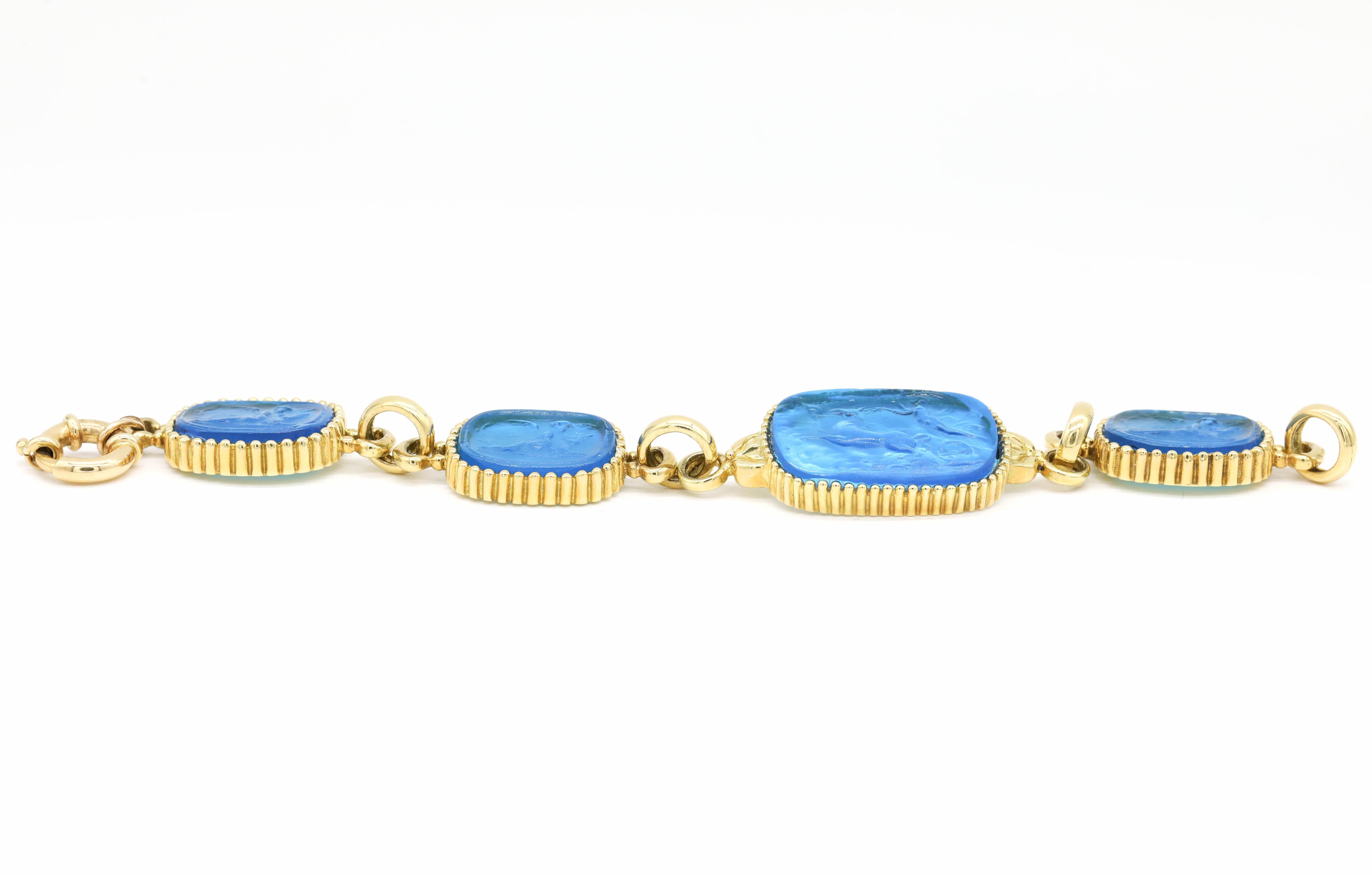 New Victorian Blue Carved Italian Murano Glass Cameo Intaglio Bracelet 18k Yellow Gold

A cameo, an intaglio is created by carving below the surface to produce an image in relief, with the purpose of pressing into sealing wax. Intaglios were often