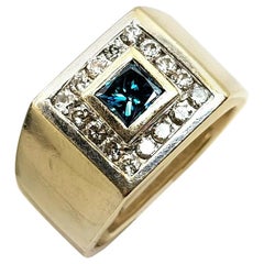 18 Karat Yellow Gold Blue Diamond Ring with White Diamonds Surrounding