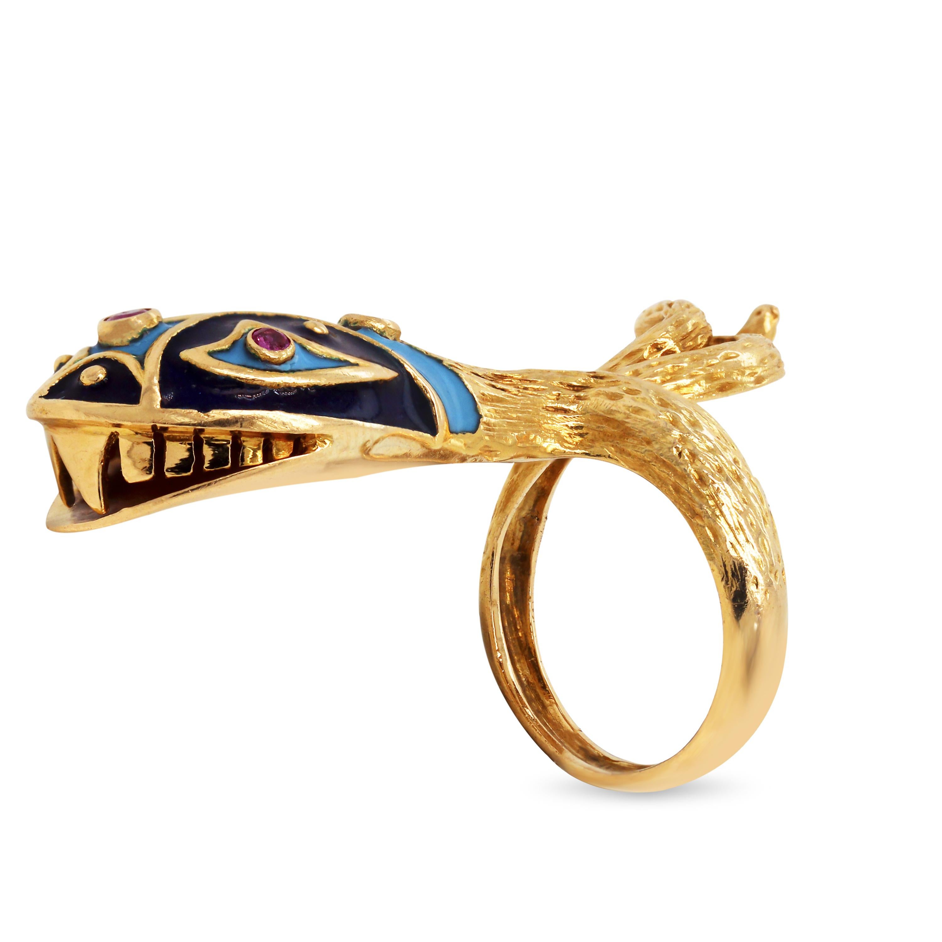 18K Yellow Gold Blue Enamel Ruby Twisted Snake Serpentine Ring

This unique ring features a snake head with a twisted tail crafted entirely in solid 18k gold. The head of the snake has navy blue and baby blue enamel with rubys. 

Apprx. 0.08 carat