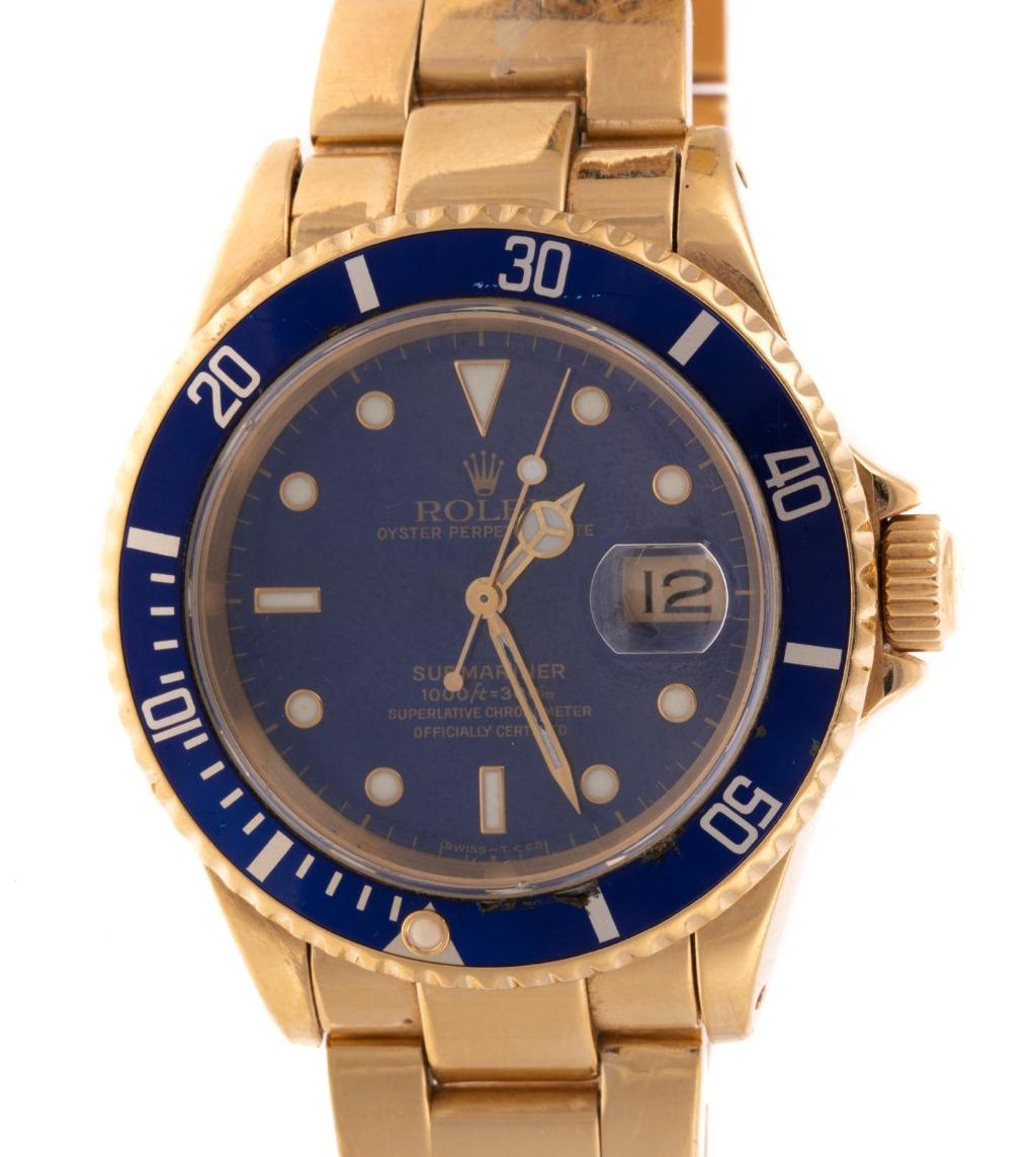 18K yellow gold Rolex Submariner, 
style #16618, serial number E868796, 
Blue face and rotating bezel, magnified window at 3 o'clock, 
18K BLUE ROLEX SUBMARINER, 16618, 40 MM
18K yellow gold Rolex link bracelet with deployment clasp, automatic