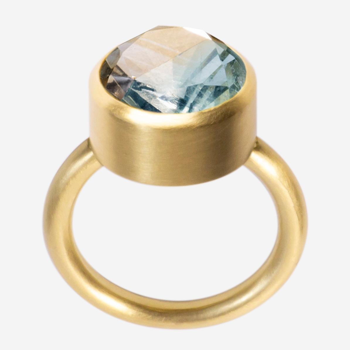 This bold and minimal statement ring is a modern take on the cocktail ring. It features a stone that is fashioned from two natural colored stones that have been fused together then cut and polished as one. When the two characteristics of the