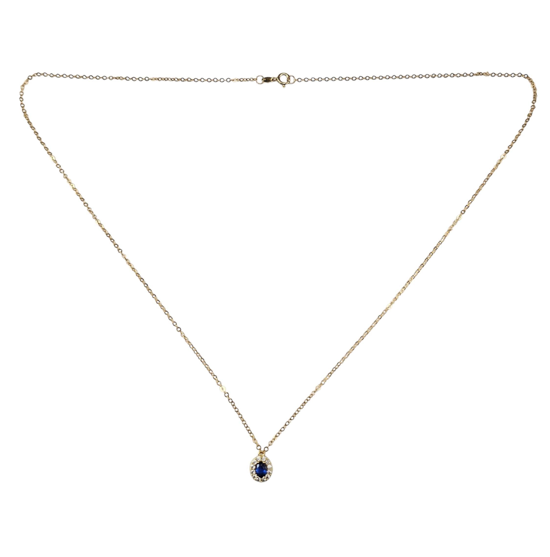 Collier à pendentif en or jaune 18K avec pierres bleues et diamants simulés-

Délicat et intemporel, ce collier en or jaune 18 carats est orné d'une pierre précieuse bleue ovale encadrée d'un halo de 12 diamants ronds simulés. Le pendentif est