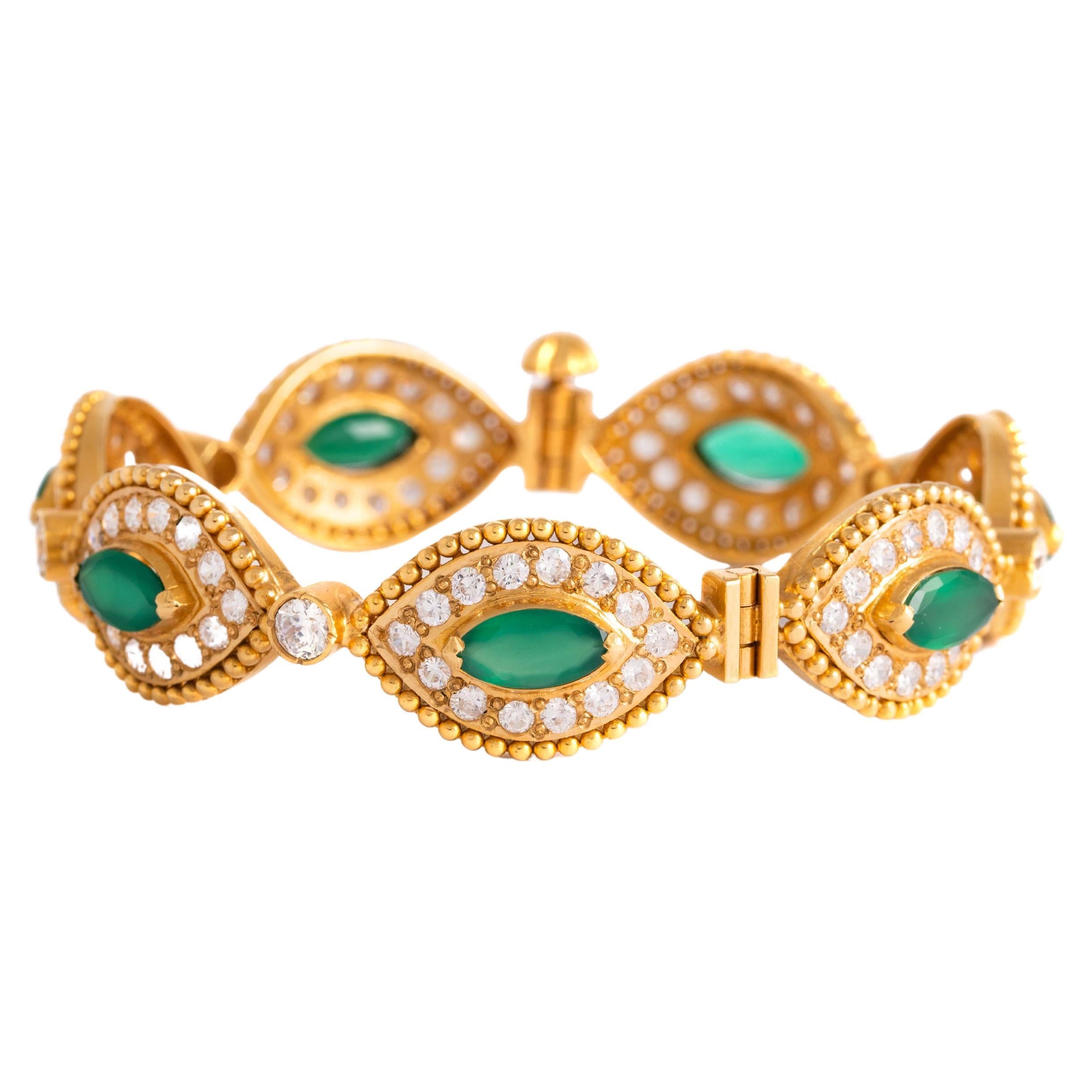 18K yellow gold bracelet set with marquise cut green stones and round cut white stones.
Circumference: 18.22 centimeters. 
Gross weight: 41.41 grams.