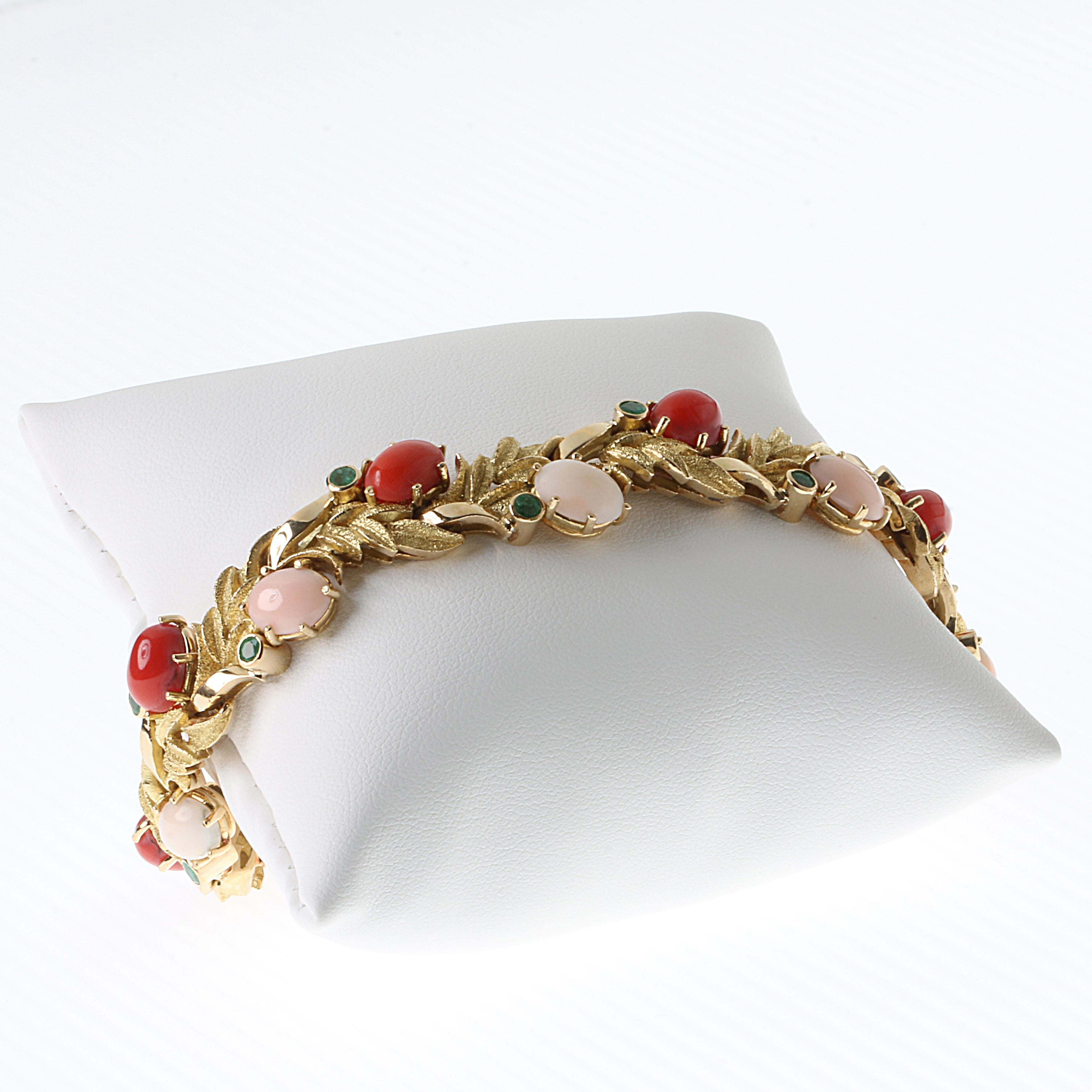 18K yellow gold bracelet with red and pink Meditteranean Coral and Emeralds. 6 red Coral oval cabochons, 6 light-pink Coral oval cabochons, all corals are Corallum Rubrum. 12 Emeralds (Cabochons deep green, transparent and matching color:  0.24cts