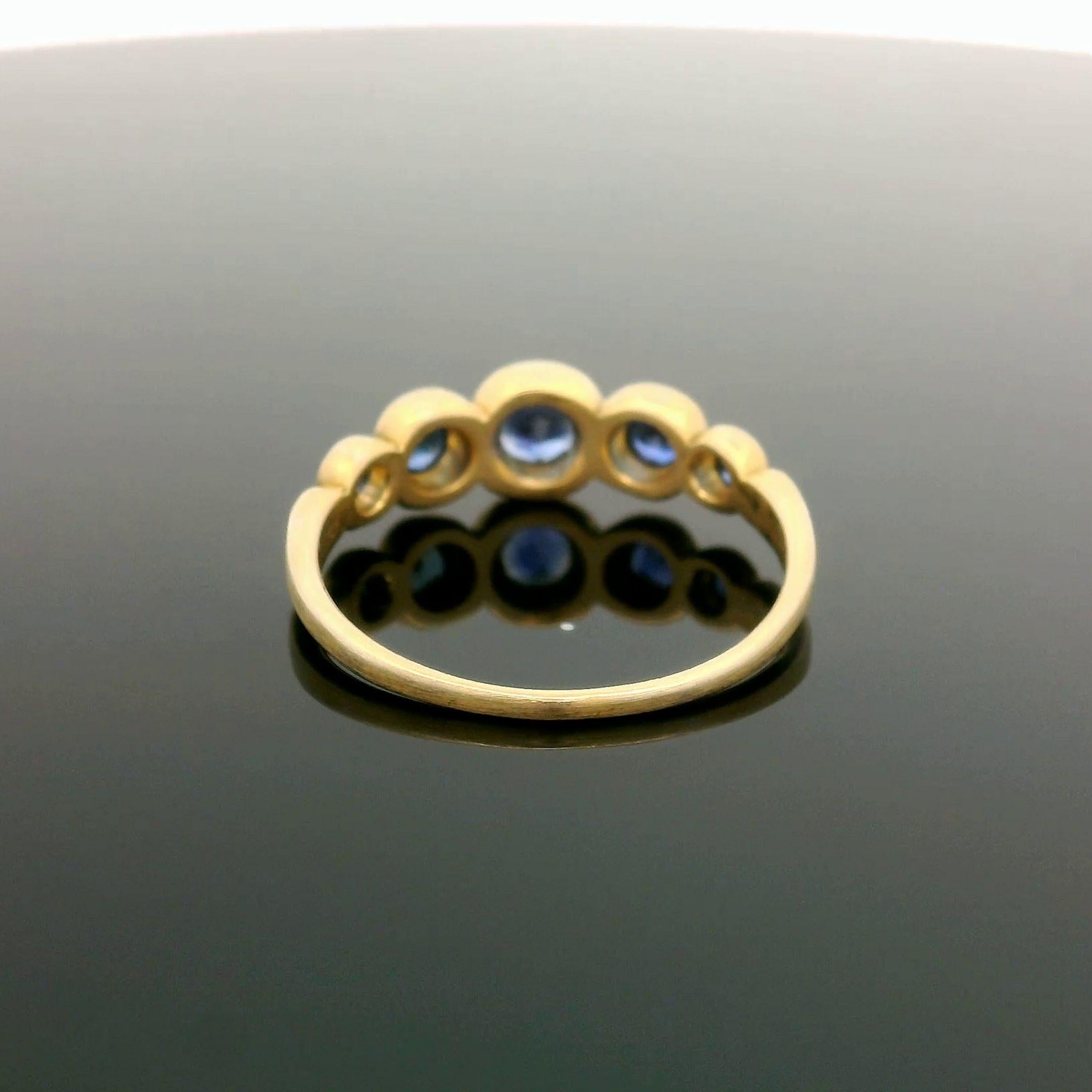 –Stone(s)–
(5) Natural Genuine Sapphire - Round Brilliant Cut - Bezel Set - Vivid Brilliant Blue Color  - 0.75ctw (approx.)

Material: 18k Yellow Gold
Weight: 2.72 Grams
Ring Size: 7.0 ( fitted on finger, please contact us prior to purchase with