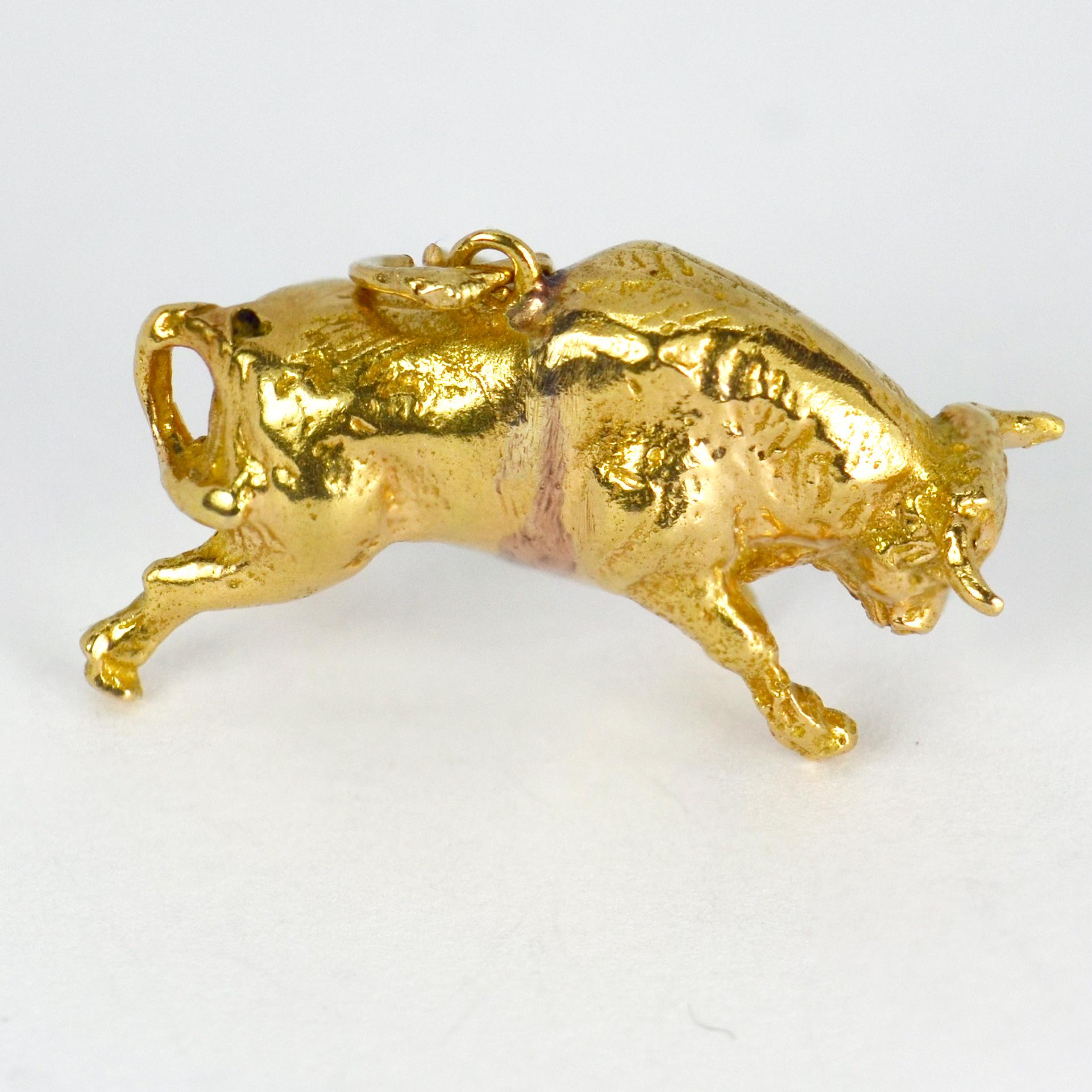 An 18 karat (18K) yellow gold charm pendant designed as a bull. Stamped 18K for 18 karat gold.

Dimensions: 2.5x 1.5 x 0.9 cm (not including jump ring)
Weight: 6.83 grams
