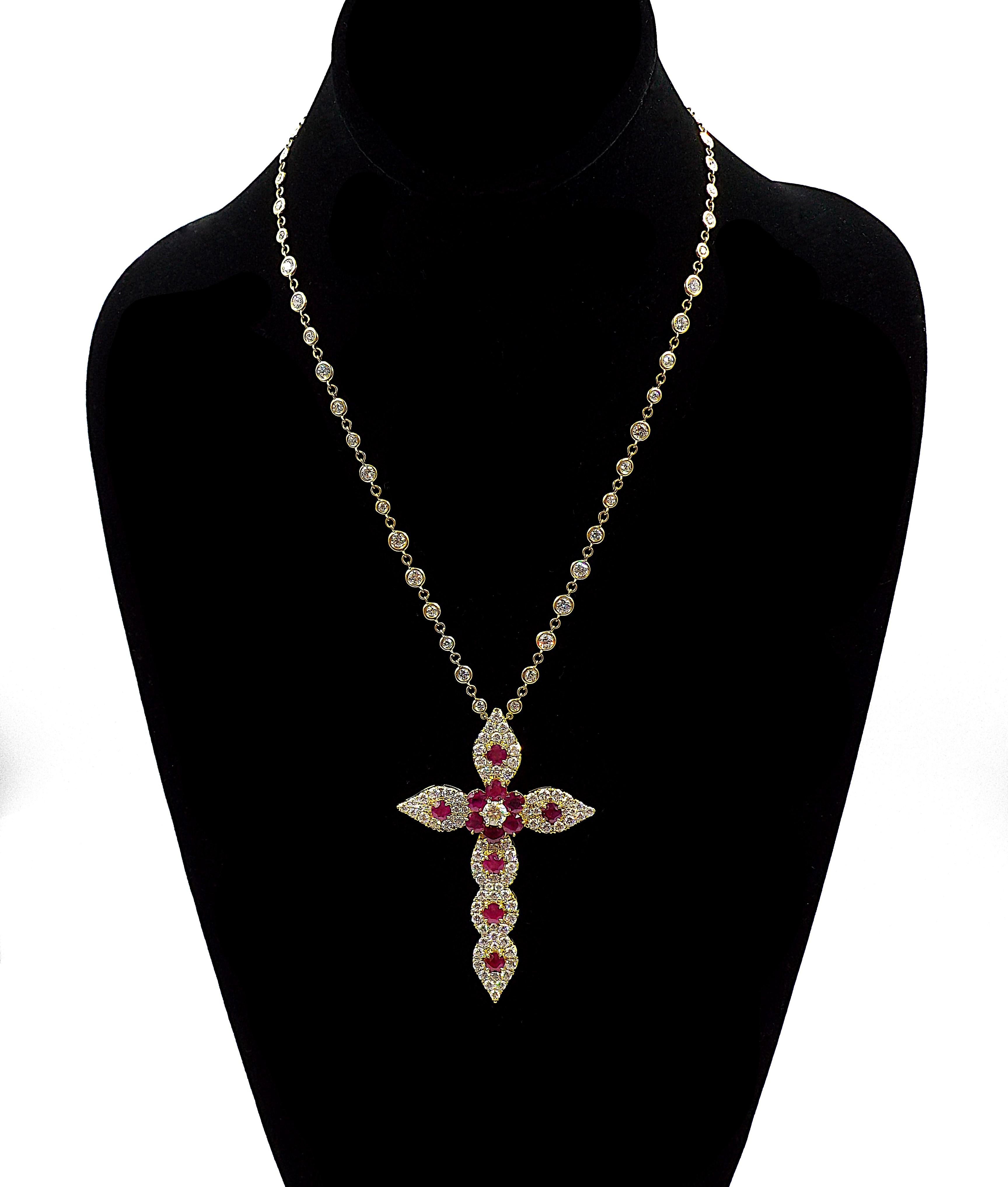 An elegant necklace with a cross pendant. Ap. 15ct of diamonds, ap. 6ct of Burma rubies, 18K yellow gold.