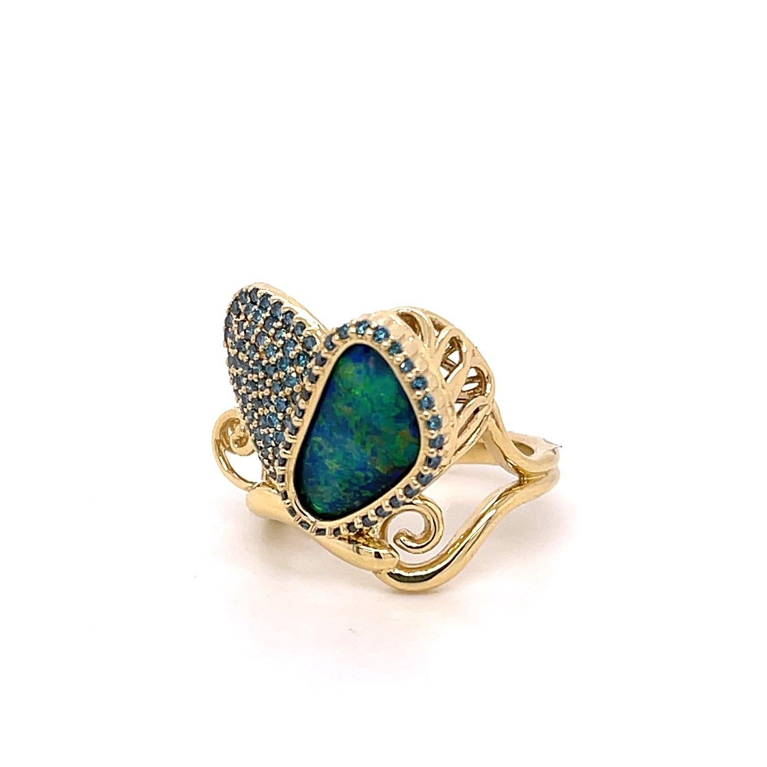 An 18k yellow gold butterfly ring set with one 1.87 carat black opal from Australia, and .60 carats of teal blue diamonds. This ring was made and designed by llyn strong.