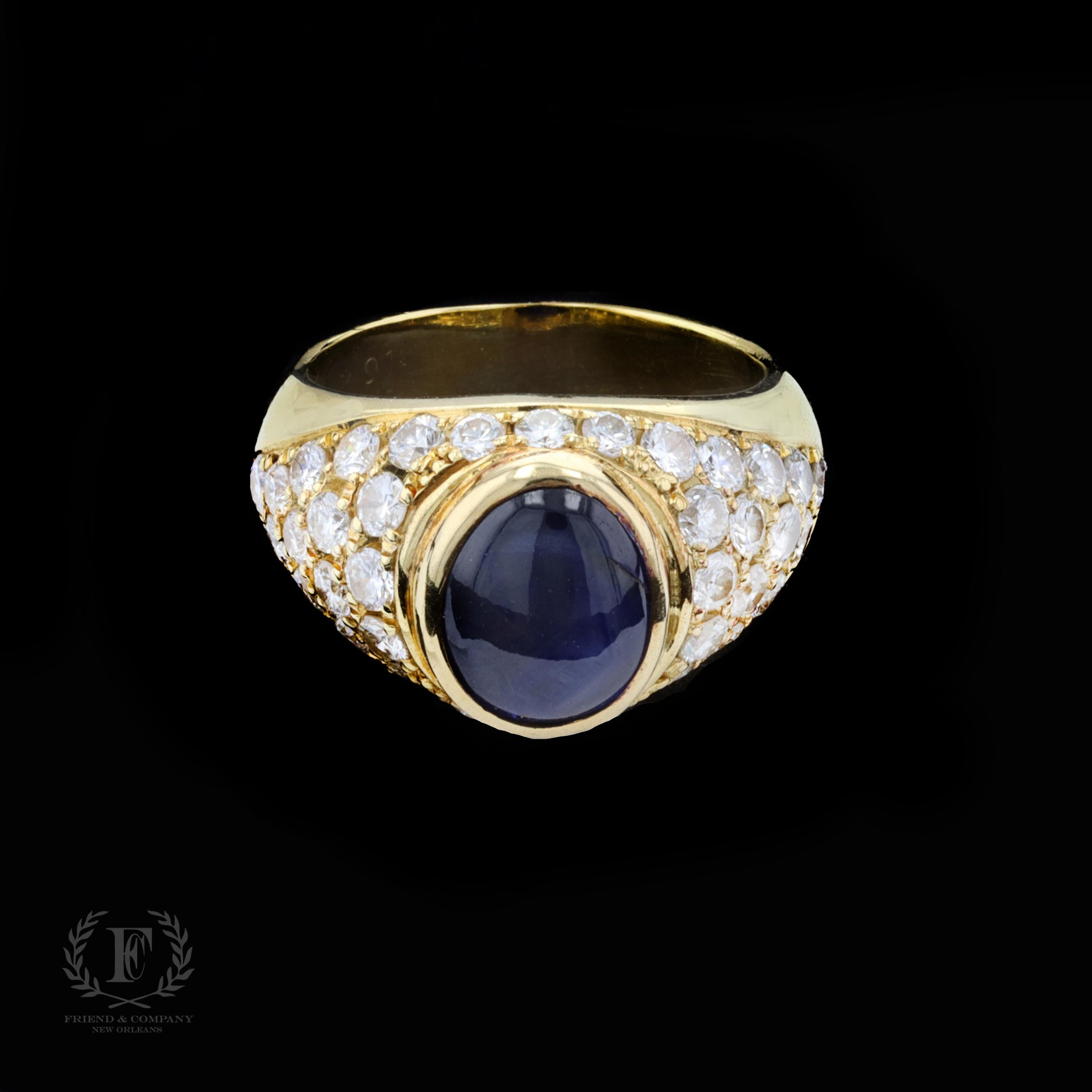The dazzling estate ring is centered with one cabochon cut blue sapphire that weighs approximately 4.00 carats. The sapphire is accentuated by round cut diamonds that weigh approximately 1.85 carats total. The color of the diamonds is G, and the