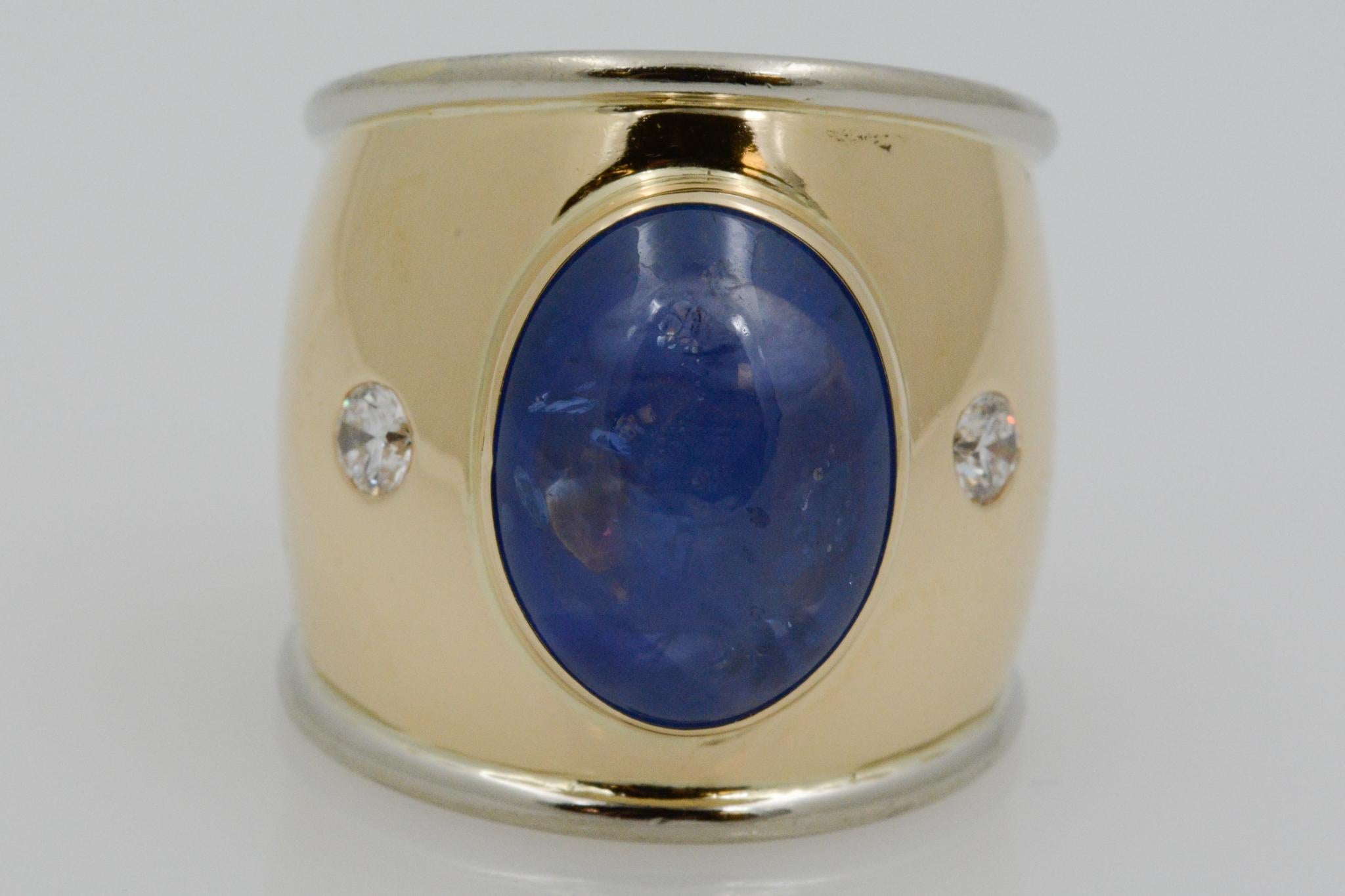 This 18k yellow gold ring features a Cabochon sapphire weighing, 9.35 carats. Accenting the sapphire are two round brilliant diamonds weighing .20 carats with H-I color and SI clarity. 