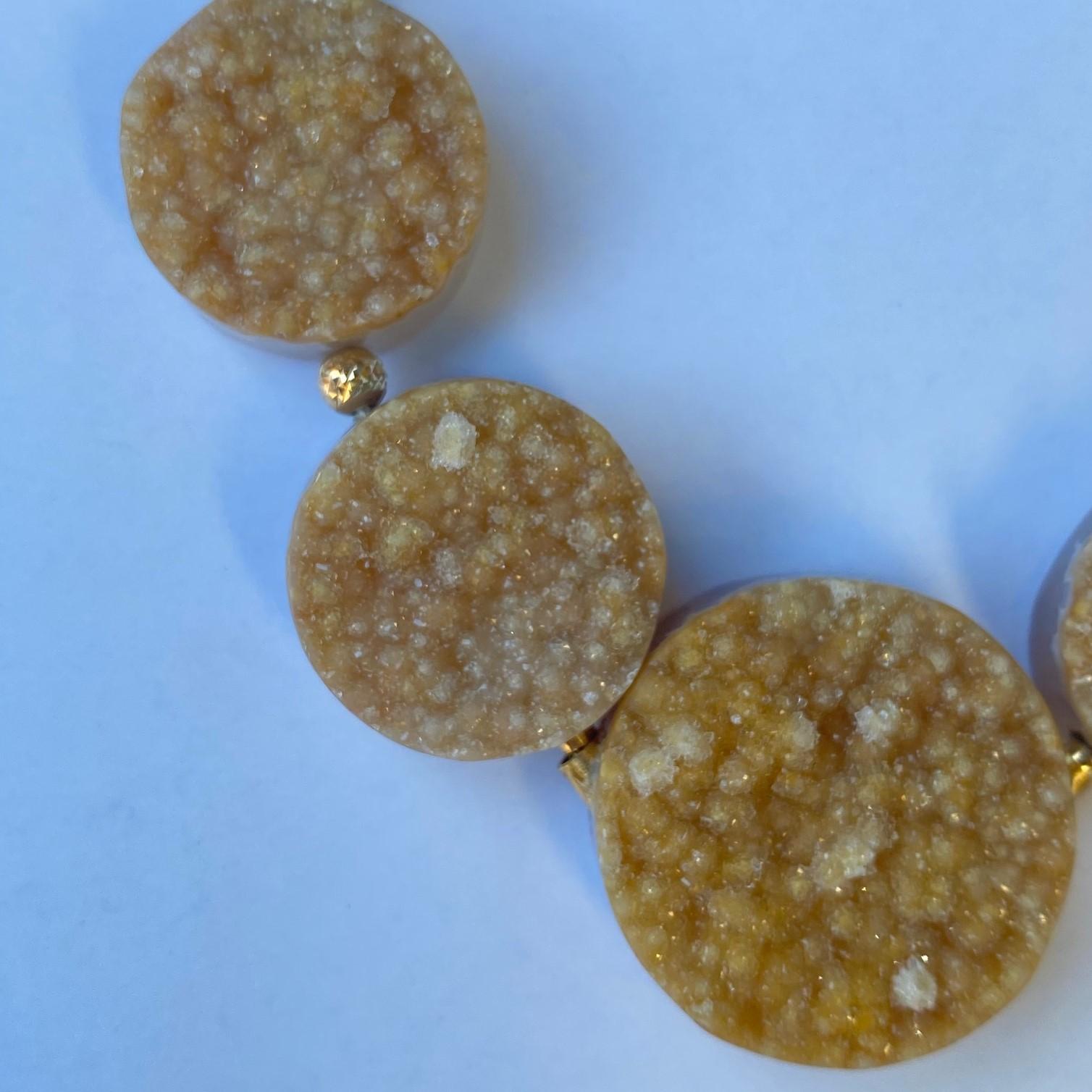 A strand of camel colored druzy quartz disks with 18k yellow gold 
