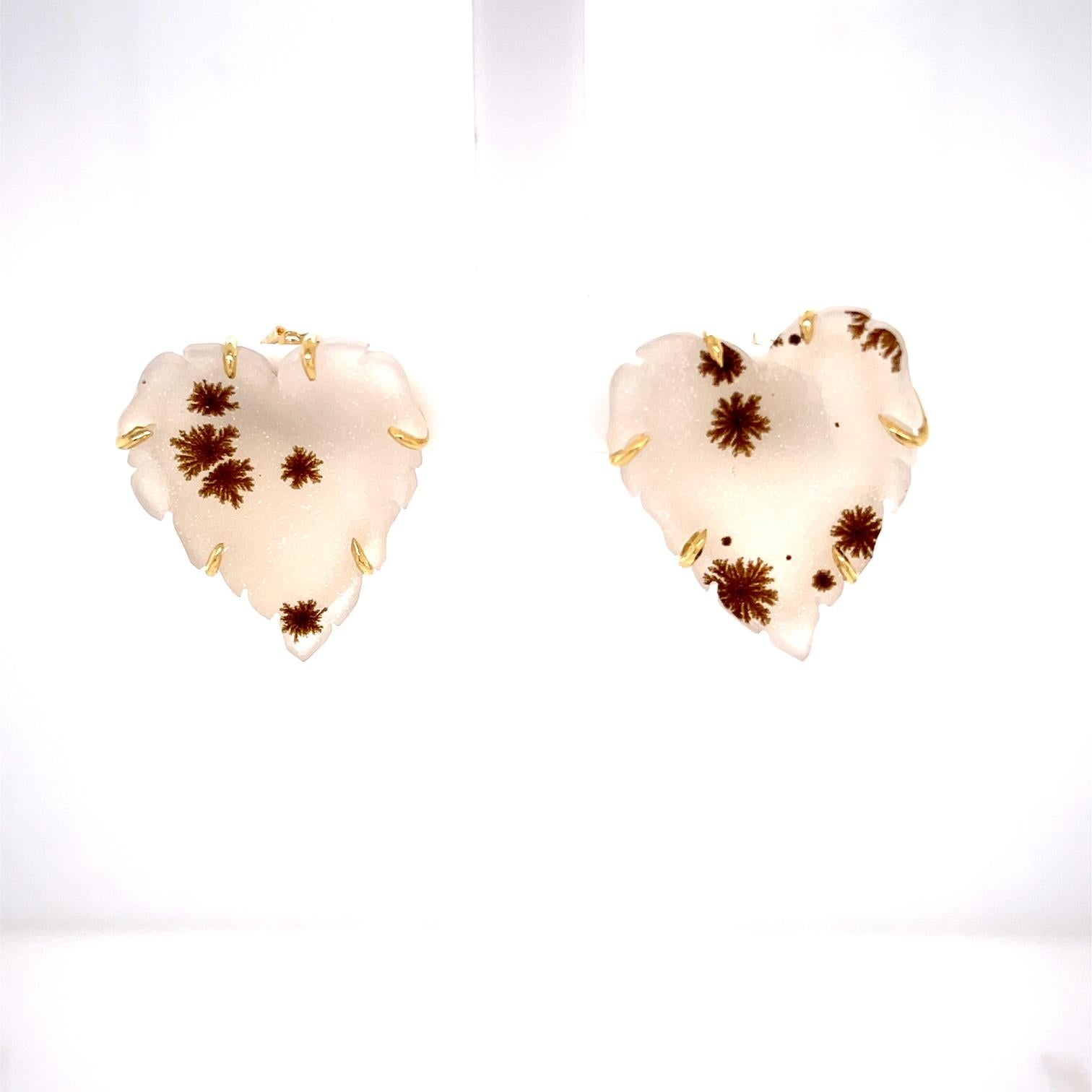A pair of 18k yellow gold carved white and speckled druzy heart studs. These studs were made and designed by llyn strong.