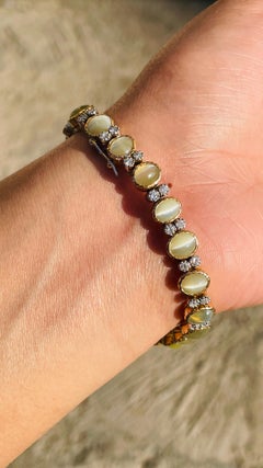 18 Karat Gelbgold Katzenauge Ovalschliff-Tennisarmband mit Diamanten