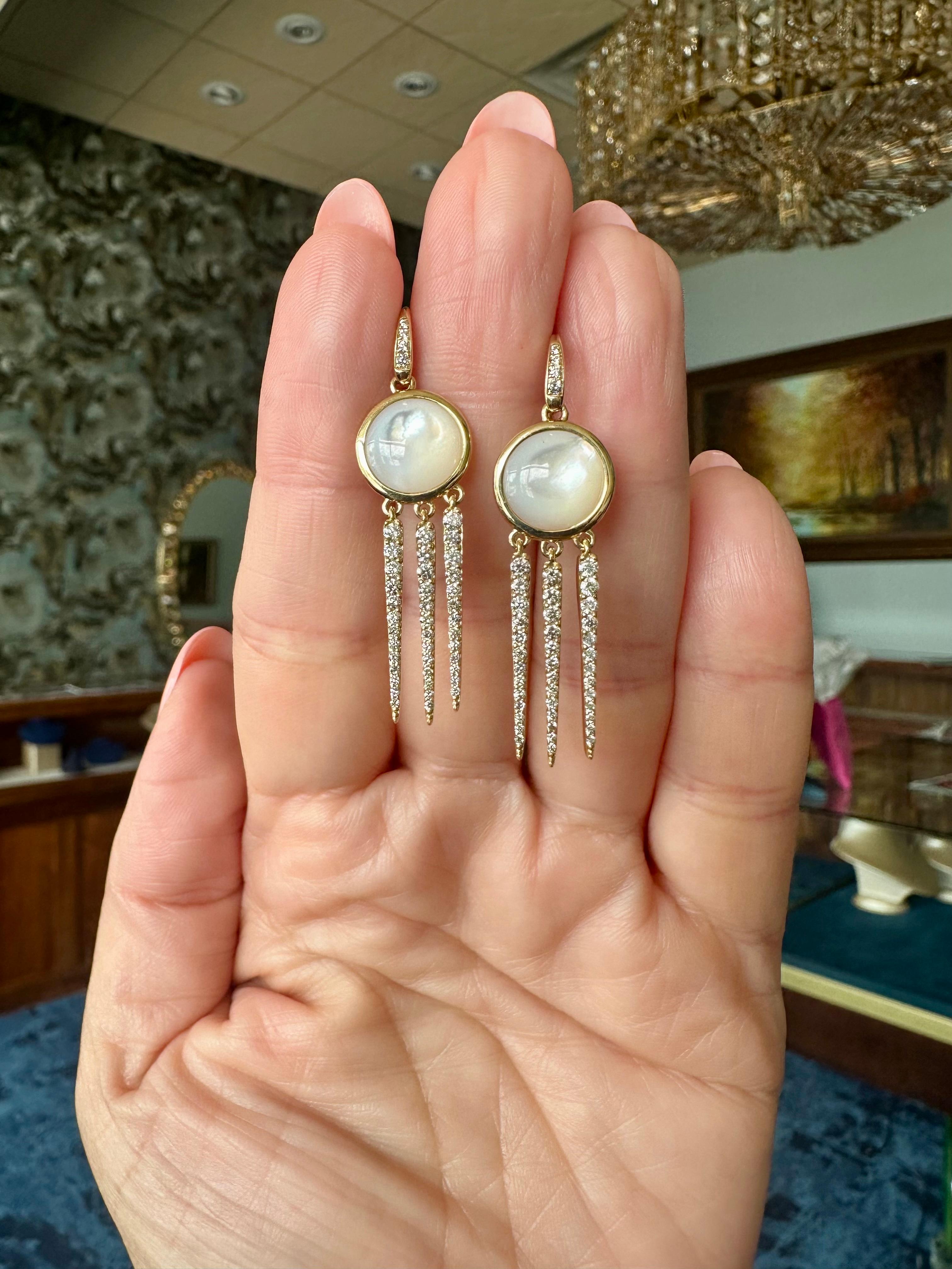 These 18K yellow gold Chakra Dream Catcher earrings by Syna feature luminous mother of pearl (approx. 6.5 ctw) accented with sparkling diamonds (approx. 0.80 ctw). Known for their modern yet timeless designs, Syna’s founders Dharmesh and Namrata