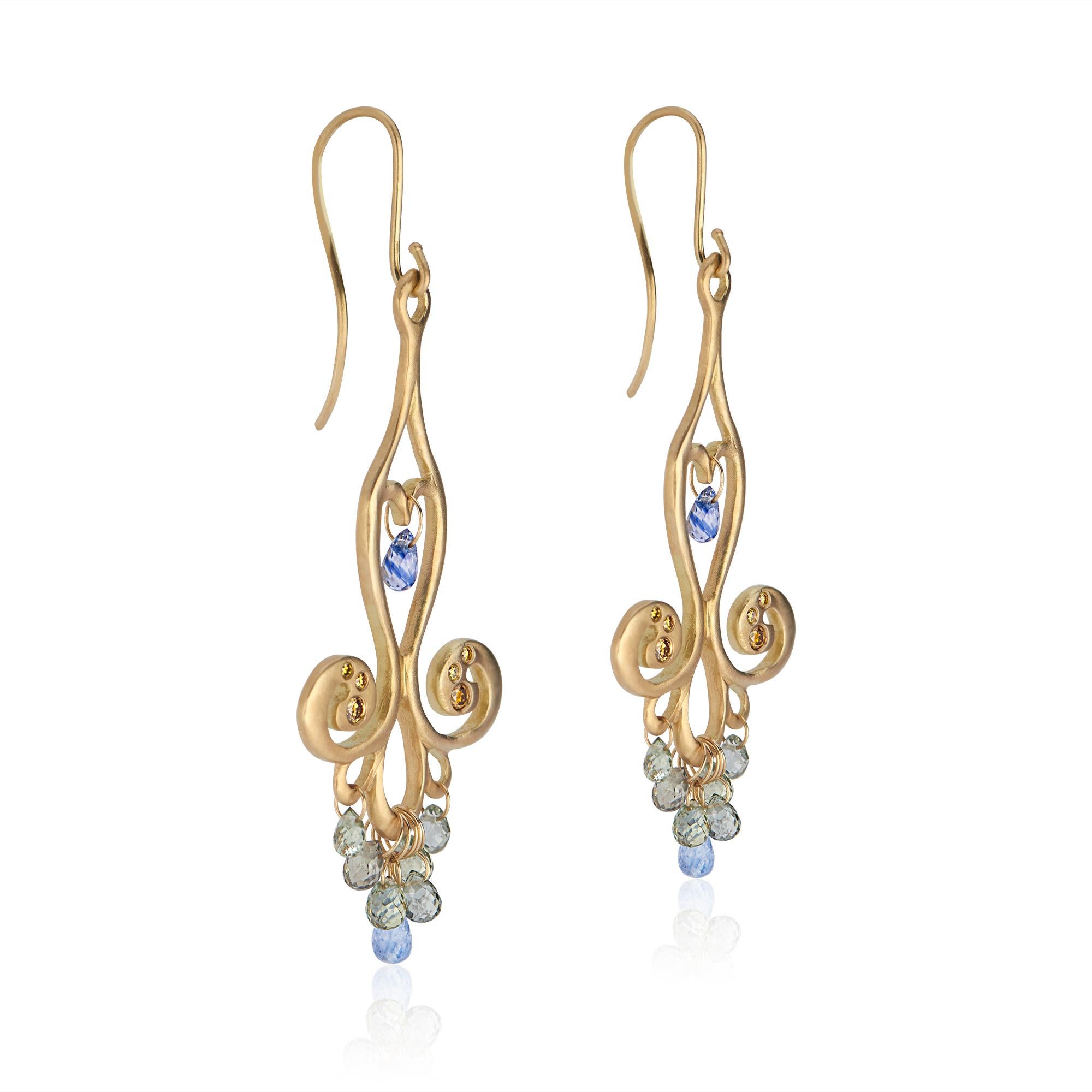 18k yellow gold
Eight blue/green sapphire teardrops (approximately 2 carats per earring)
Six canary diamonds (approximately .113 carats per earring)
18k gold earwire
Matte finish
Chandelier pendants with stones approximately 1.6 inches (4