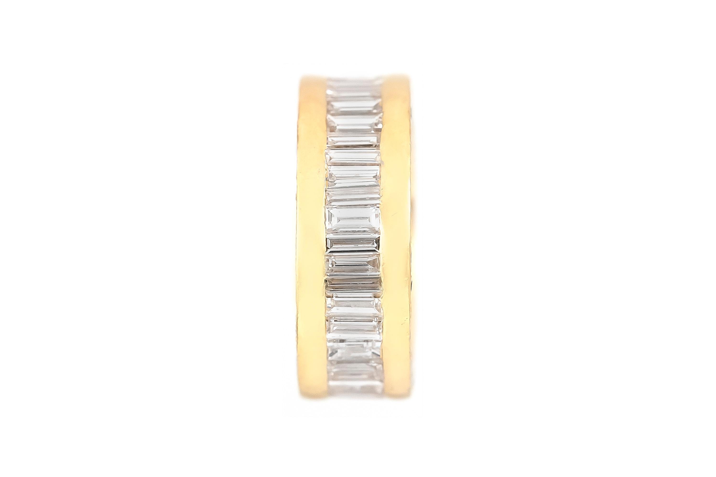 Finely crafted in 18k yellow gold with channel set Baguette cut diamonds weighing approximately a total of 14.35 carats.
H-I color, VS2-SI1 clarity
The band features Round Brilliant cut diamonds on the side, weighing approximately a total of 1.30