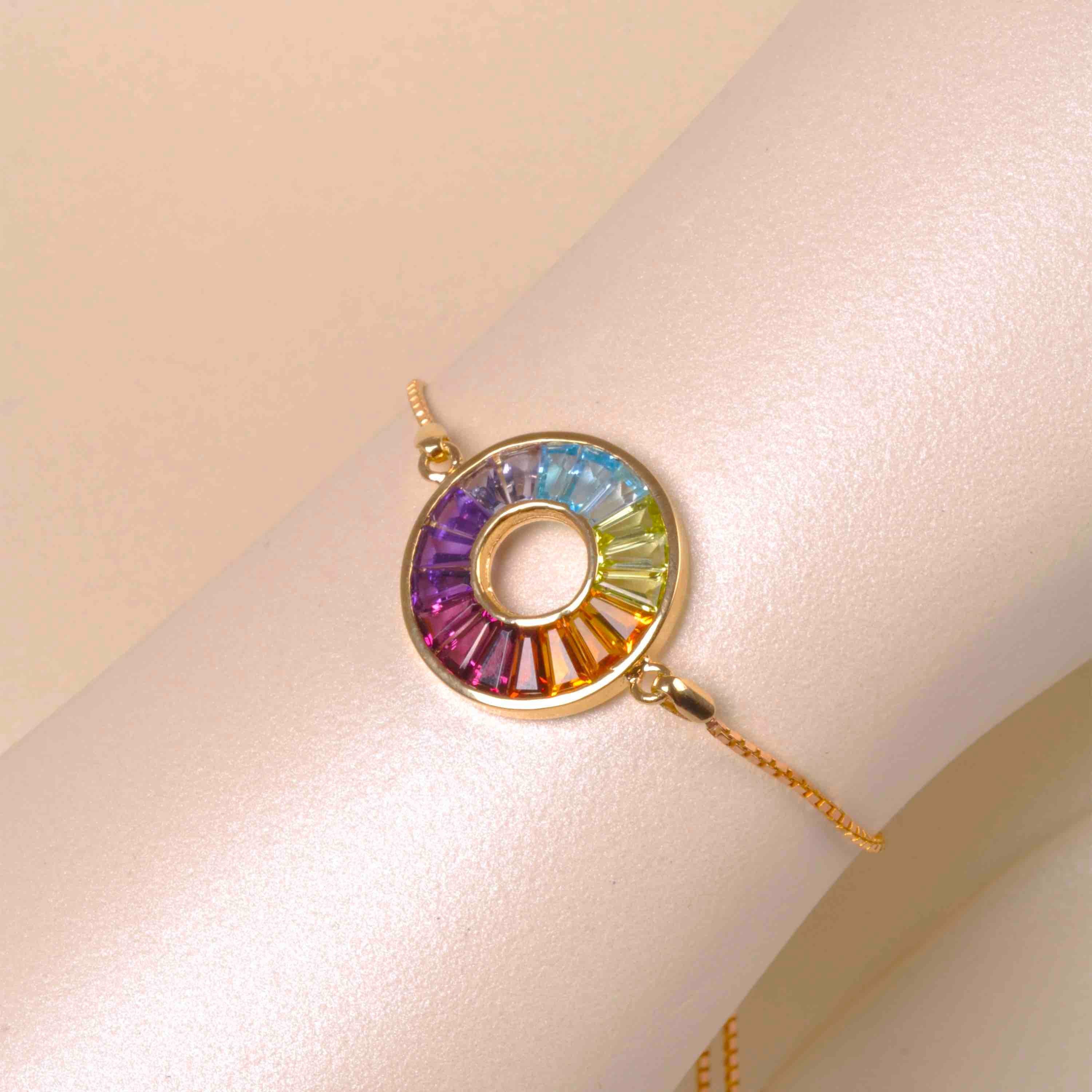 This multicolor rainbow circle bolo bracelet is a vibrant celebration of uniqueness. This elegant piece features a captivating circle adorned with meticulously arranged gemstones, creating a mesmerizing spectrum of hues that dance with every