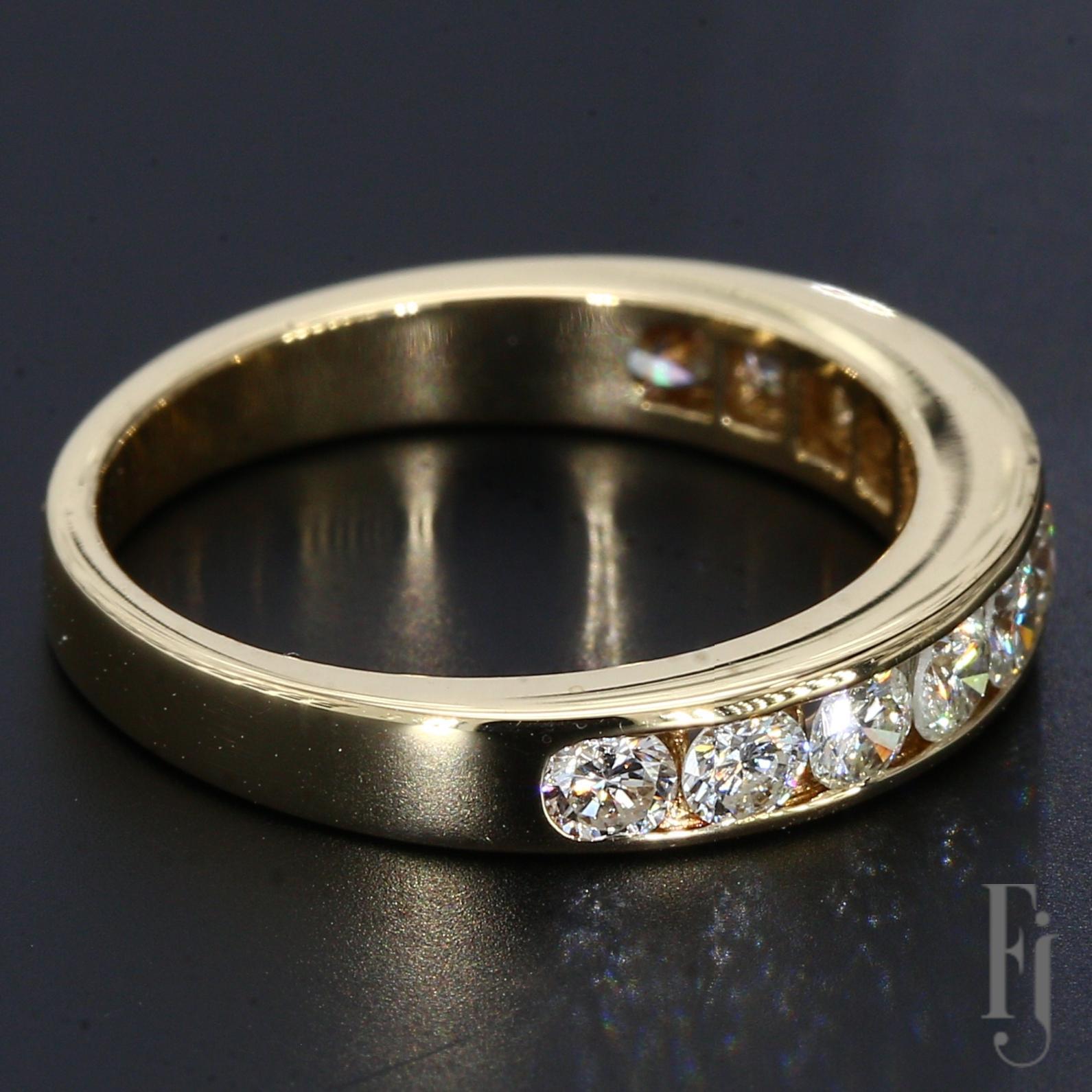 This is an 18k yellow gold and diamond ring brought to a high shine with eleven round brilliant diamonds in a channel setting across the band.

Stone Information:

11x Diamond Grading - Clarity VS1 
