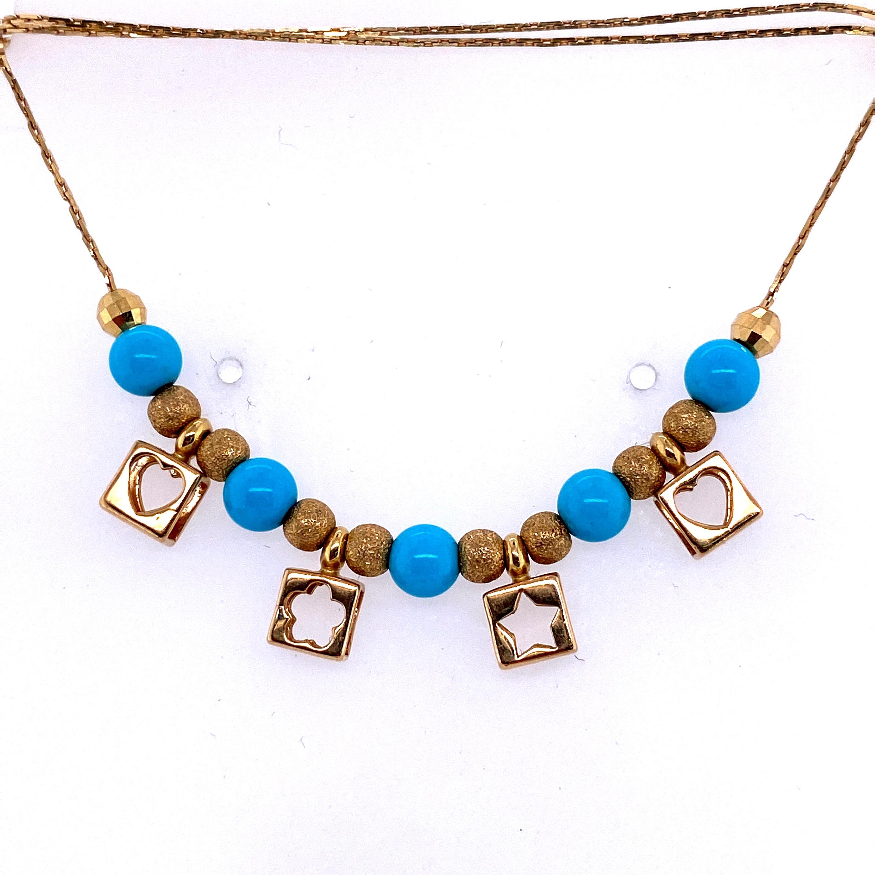 18K Yellow gold necklace featuring hearts & star charms with turquoise and gold beads. 