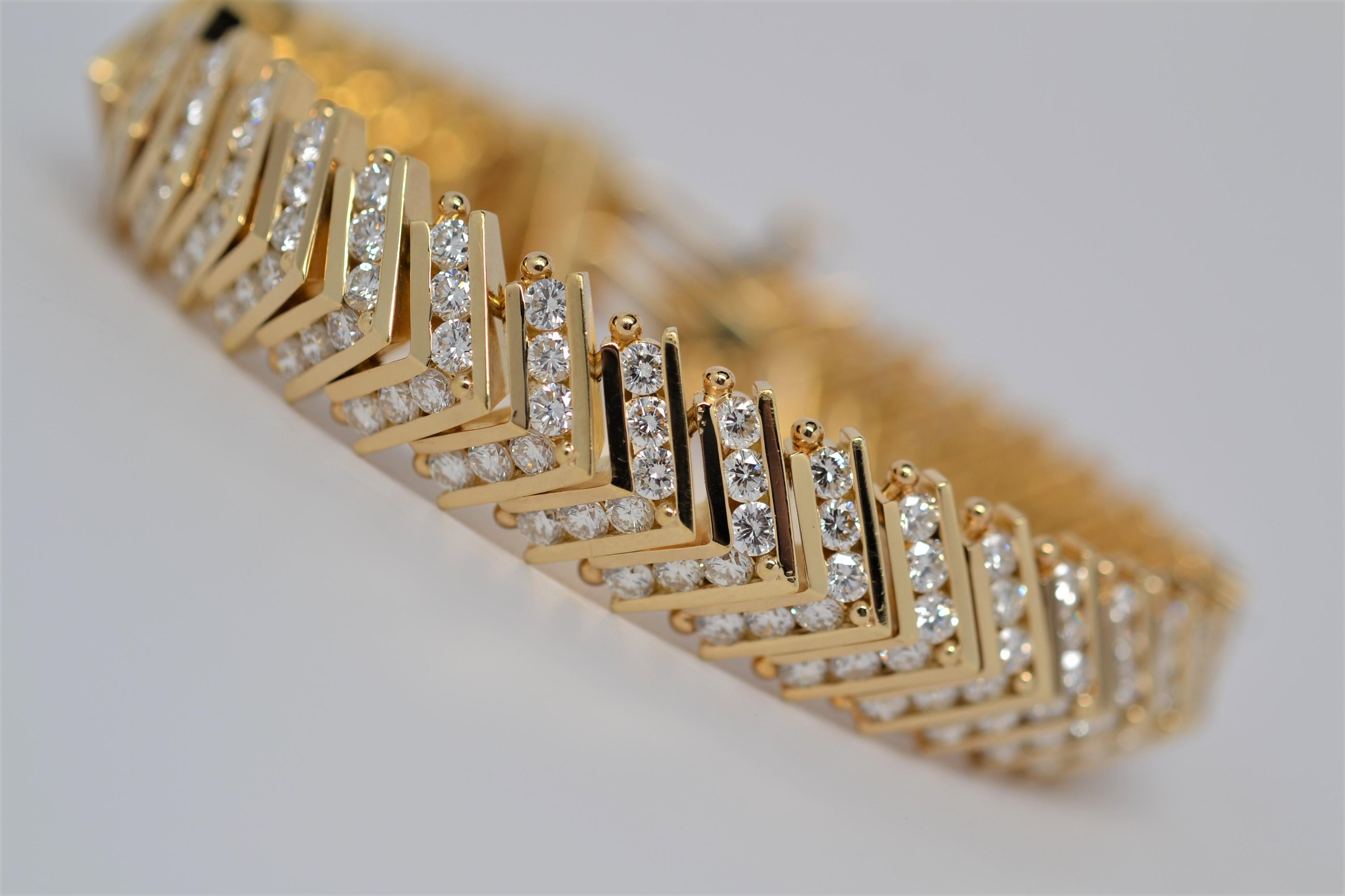 A handmade ladies 18K Yellow Gold bracelet with multi link Chevron layout. Each link is set with diamonds using a channel in the Chevron and a shared bead for the center. A total of two hundred and twenty two Round Brilliant Cut Diamonds weighing