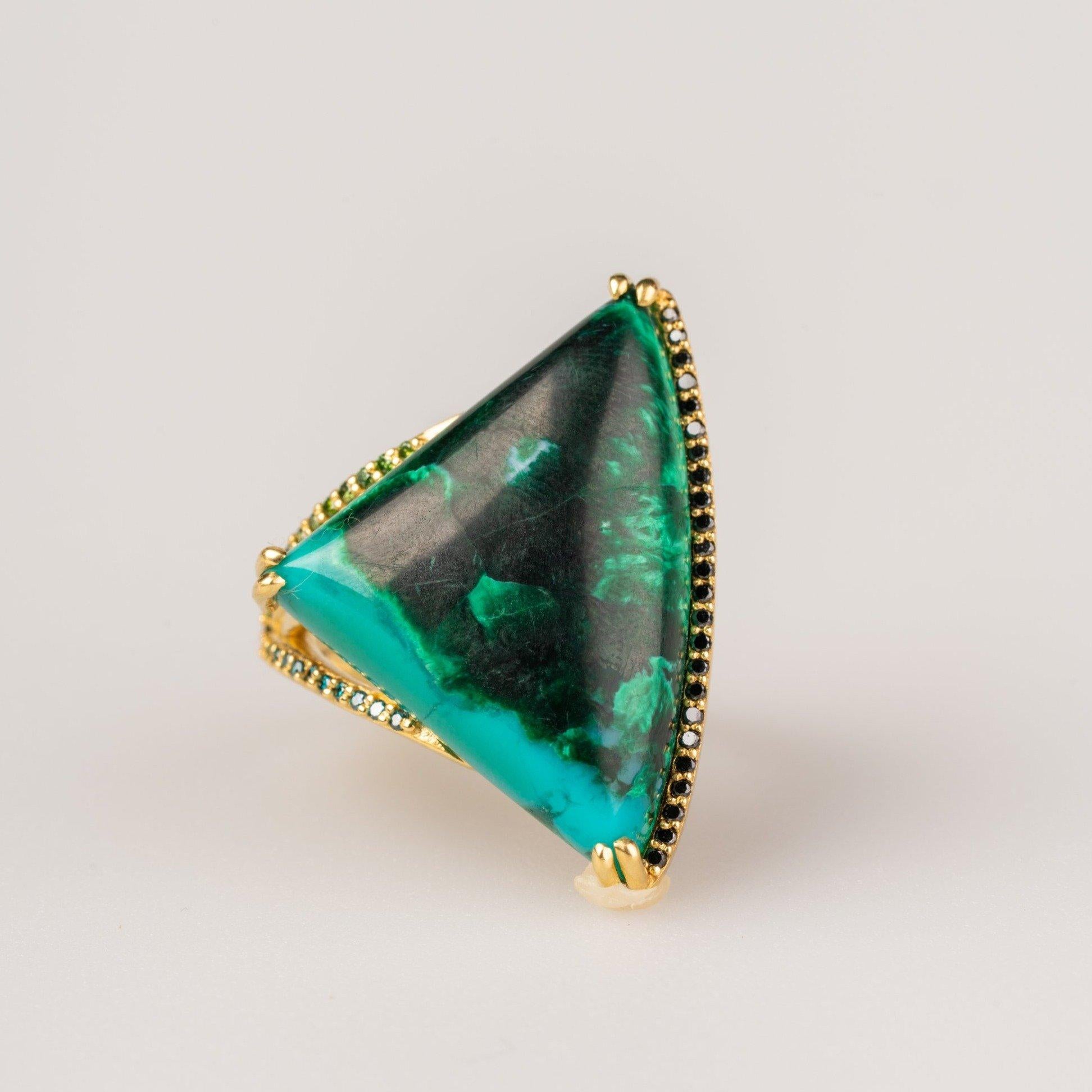 An 18k yellow gold split shank ring featuring one double prong set pie shaped chrysocholla/malachite, and accented by round full cut black, teal blue, and dark green diamonds, .25 carats. Ring size 7. This ring was designed and made by Sydney Strong.