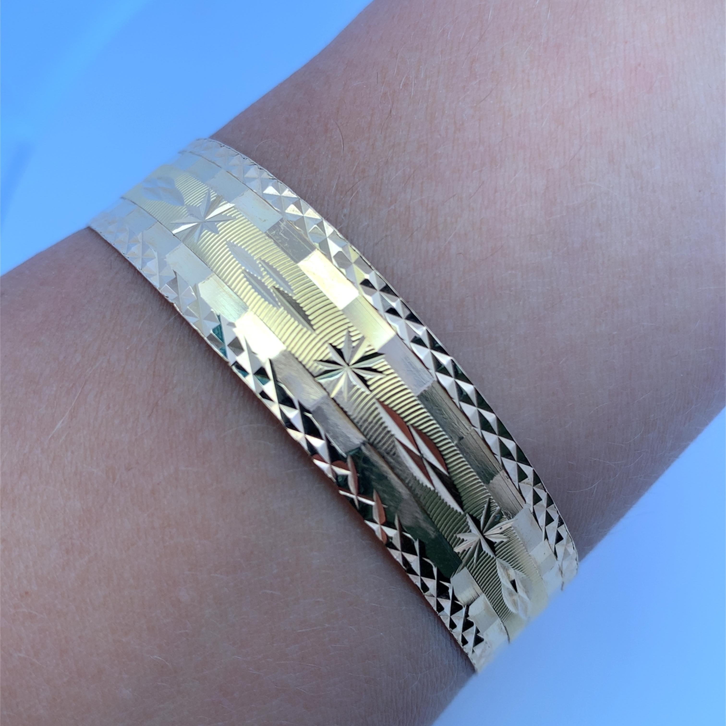 Elevate your style with this exquisitely crafted 18k yellow gold cuff bangle. The intricate detailing and radiant finish create a luxurious accessory, perfect for adding a touch of sophistication to any ensemble. A timeless piece that exudes