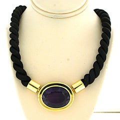 18k yellow gold clasp set with an amethyst on a black rope necklace - 28.4 grams