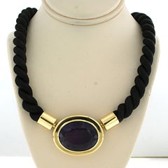 18k yellow gold clasp set with an amethyst on a black rope necklace - 28.4 grams