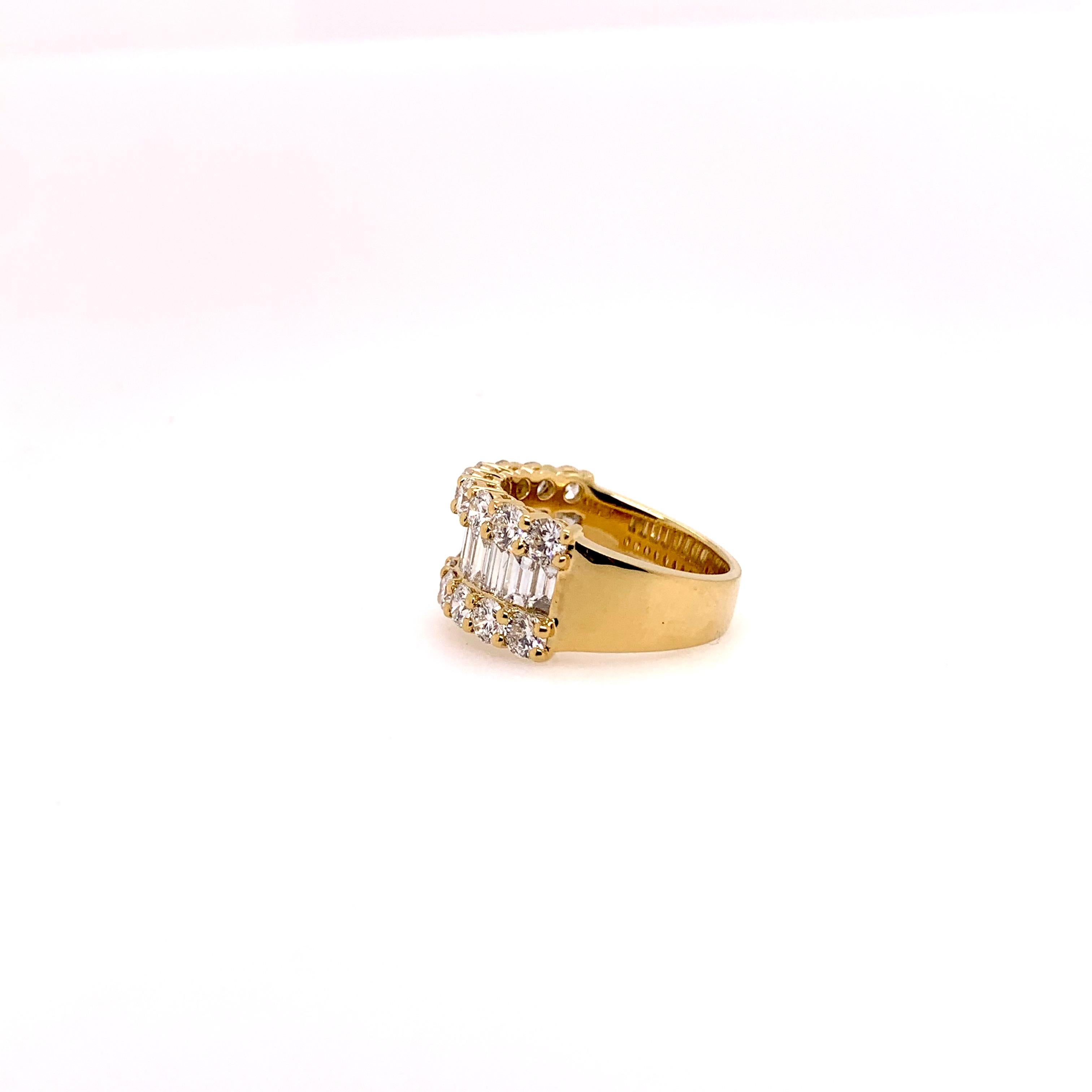 This timeless diamond band will forever be in style for any casual or formal occasion. This 18k yellow gold band has large round brilliant diamonds prong set on the edges while the diamond baguettes are the center focus.  The diamonds come to 3.46
