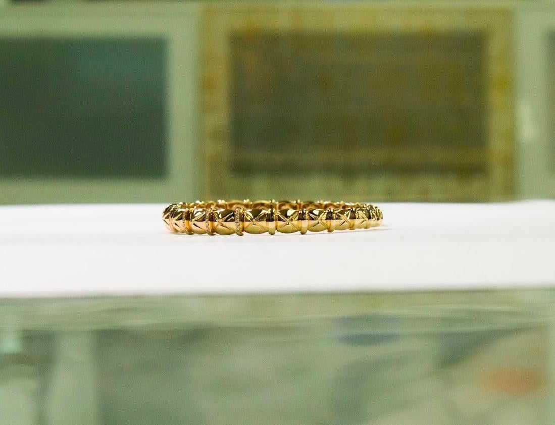 •	Metal: 18K Yellow Gold 
•	Weight: 13.51gm
•	Gemstones: Natural Diamonds
•	Total Diamond Weight: 0.33 ct (90 stones)
•       Diameter of bracelet: 1.8 inch - 2.3 inch

Inspired by the essence of renewal, this yellow gold bangle features 90 dazzling