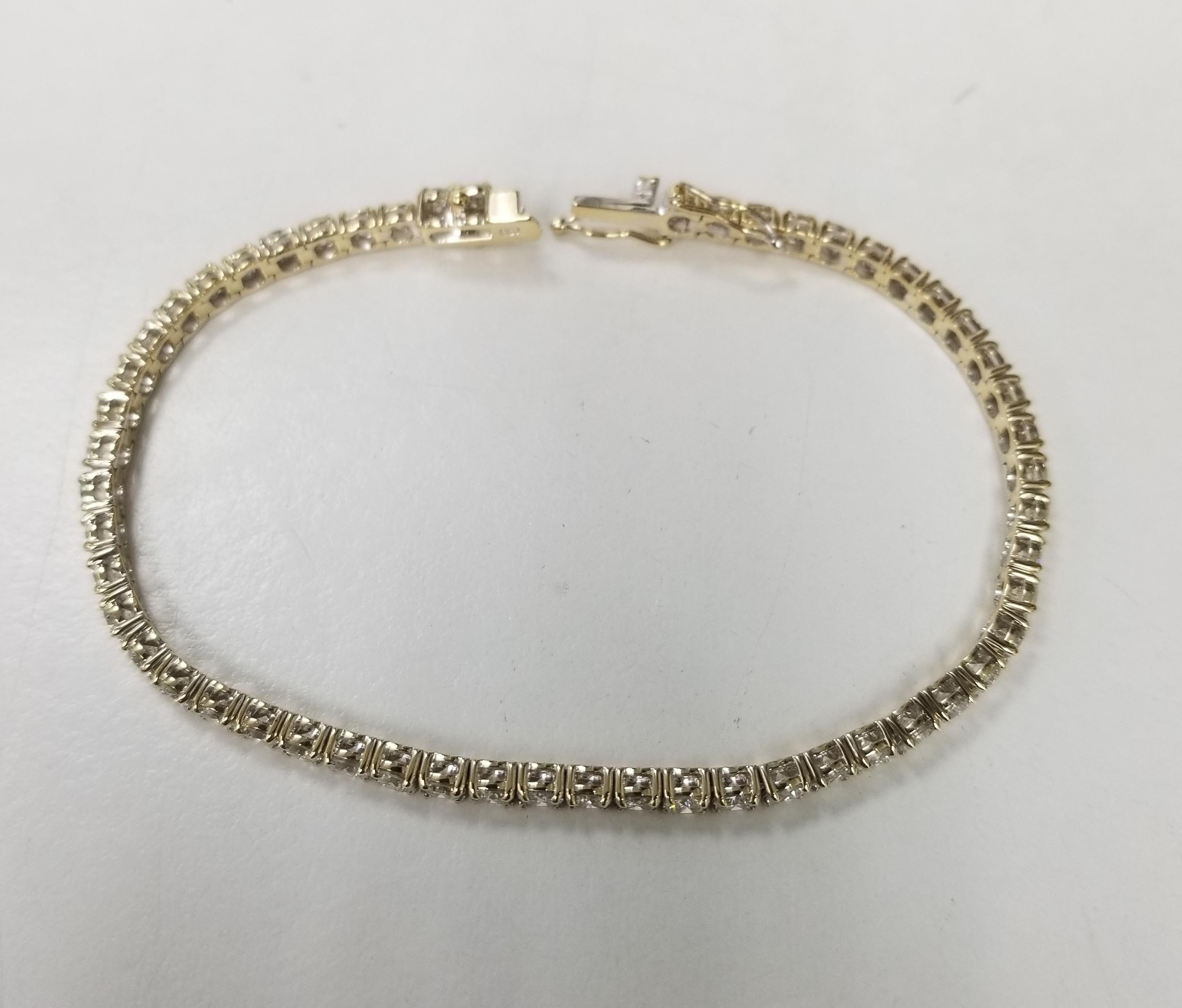 This is very beautiful 18k yellow gold classic custom diamond tennis bracelet with 54 round diamonds color F-G and clarity VS2-SI1 weighing 5.80cts. very fine quality diamonds, bracelet measures 7inches with clasp and a double