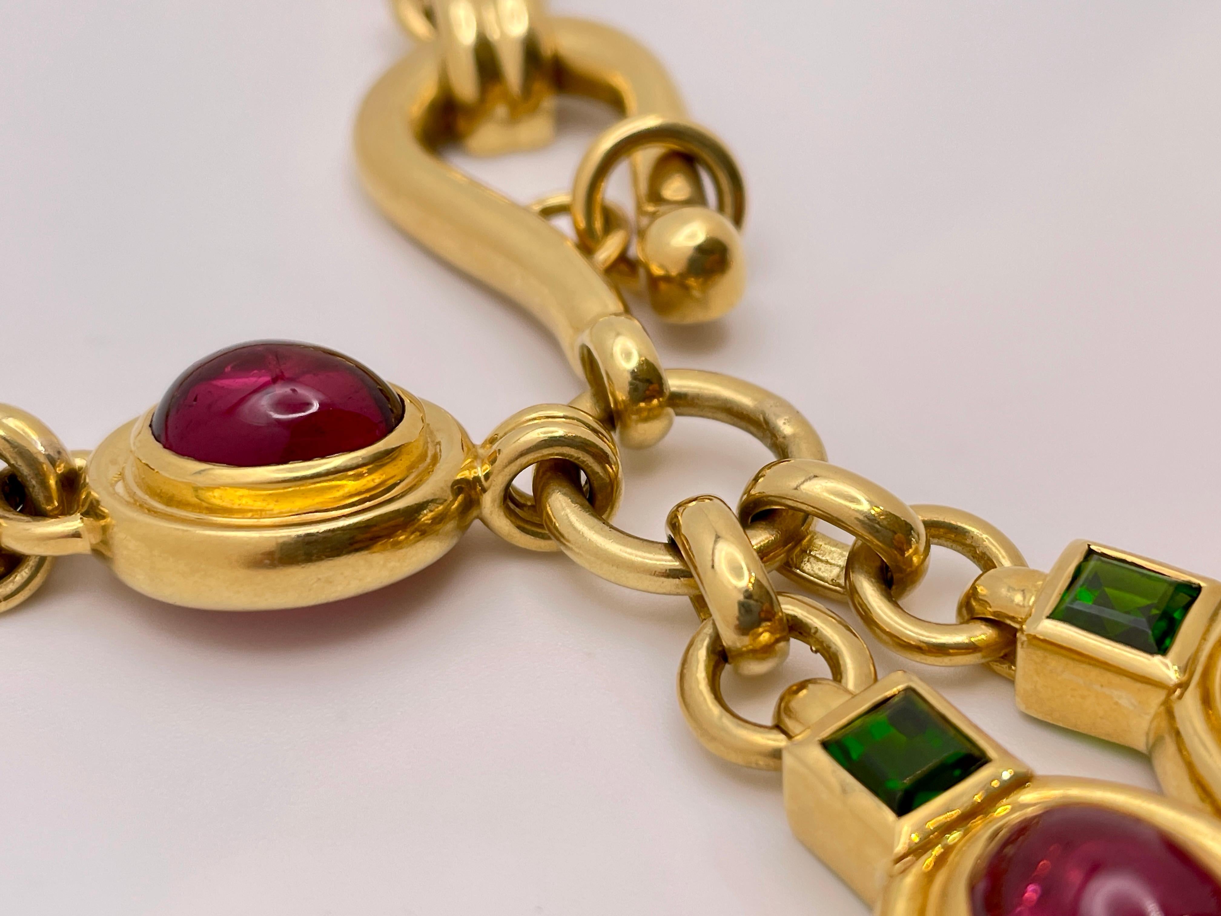 An extraordinary 18K yellow gold green and pink turmaline necklace. Mounted with three oval cabochon cut turmaline stones, weighing a total of approximately 15 CT, and two smaller square cut turmaline stones weighing a total of approximately 3 CT.