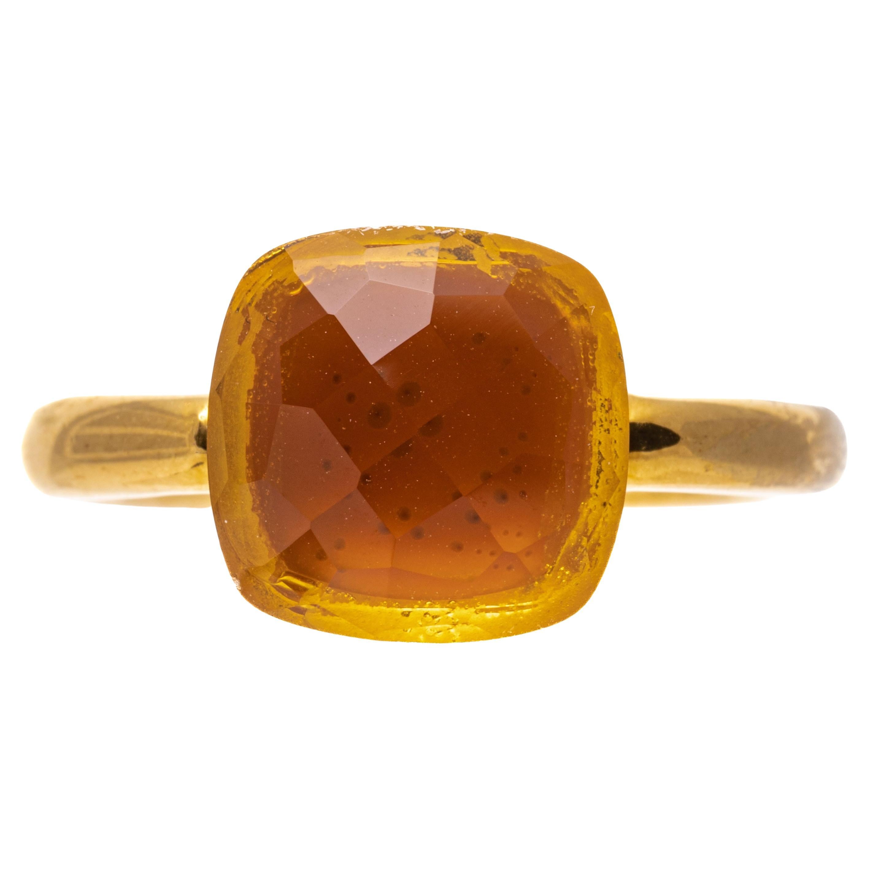 18k yellow gold ring. This beautiful, contemporary ring features a checkerboard cushion cut, medium yellow orange color citrine, approximately 3.04 CTS, set atop a yellow gold simple tube style shank.
Marks: 18k
Dimensions: 3/8