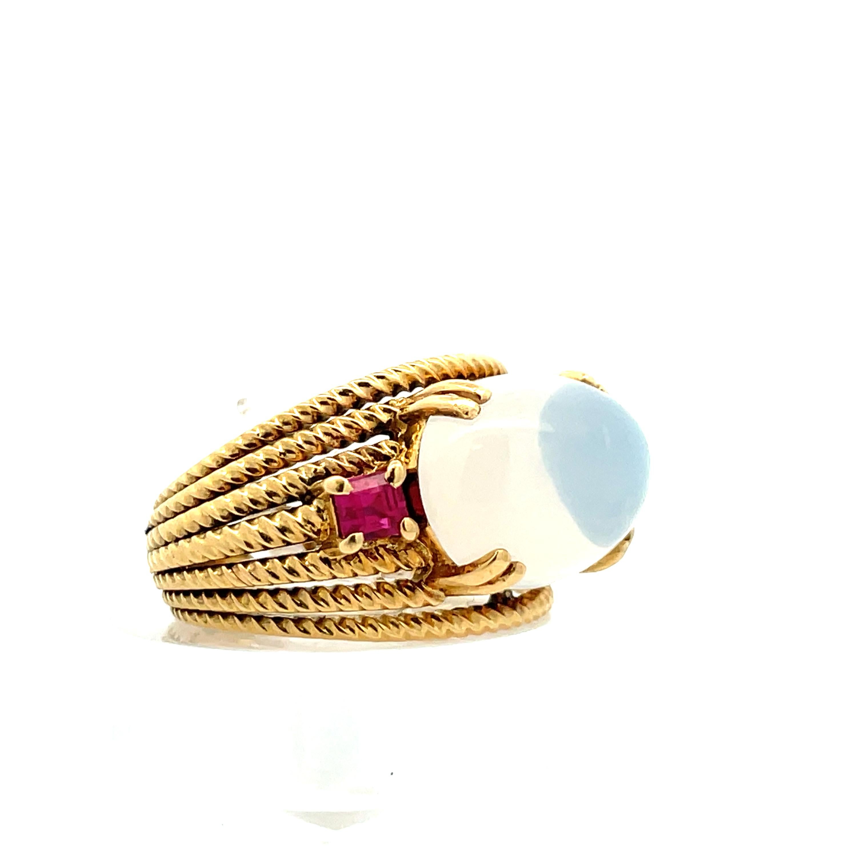 This beautiful 18k yellow gold ring is contemporary-design handmade with moonstone and rich red
rubies. The 18k yellow gold rope design bands are stacked and raised, effortlessly displaying the
moonstone and ruby, making the details of the ring