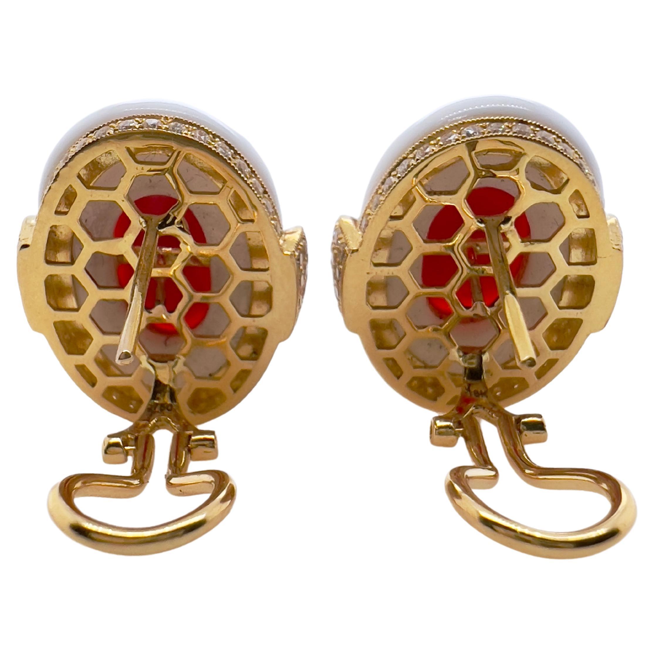 This gorgeous handmade earrings will be the talk of the town.  The amazing coral is vibrant in color and luster.  It is set in the middle of a custom white agate that is strategically placed in an 18k yellow gold setting with diamonds.  The unique