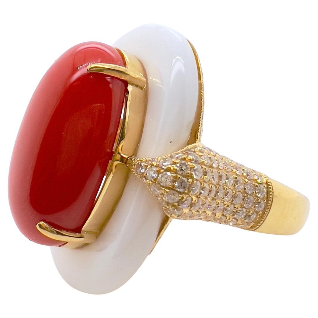 This gorgeous handmade ring will be the talk of the town.  The amazing coral is vibrant in color and luster.  It is set in the middle of a custom white agate that is strategically placed in an 18k yellow gold setting with diamonds.  The unique color