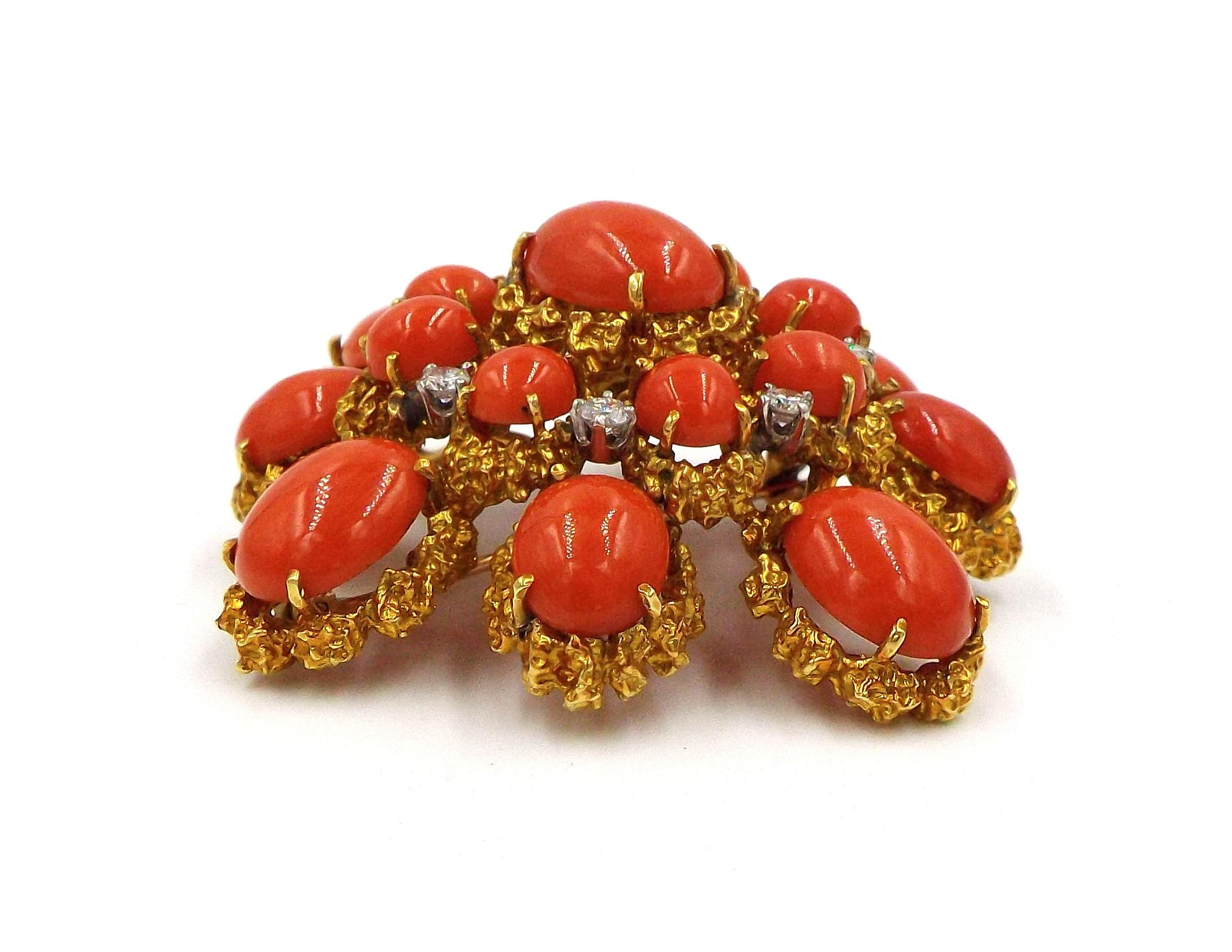 Set with oval coral cabochons and round diamonds within a textured gold mounting
METAL: 18k yellow gold
DIAMONDS: 8 round diamonds with approximate total weight of 0.5 carat
STONES: 17 oval coral cabochons
SIZE/DIMENSIONS: 6.0 x 5.5 cm
GROSS WEIGHT: