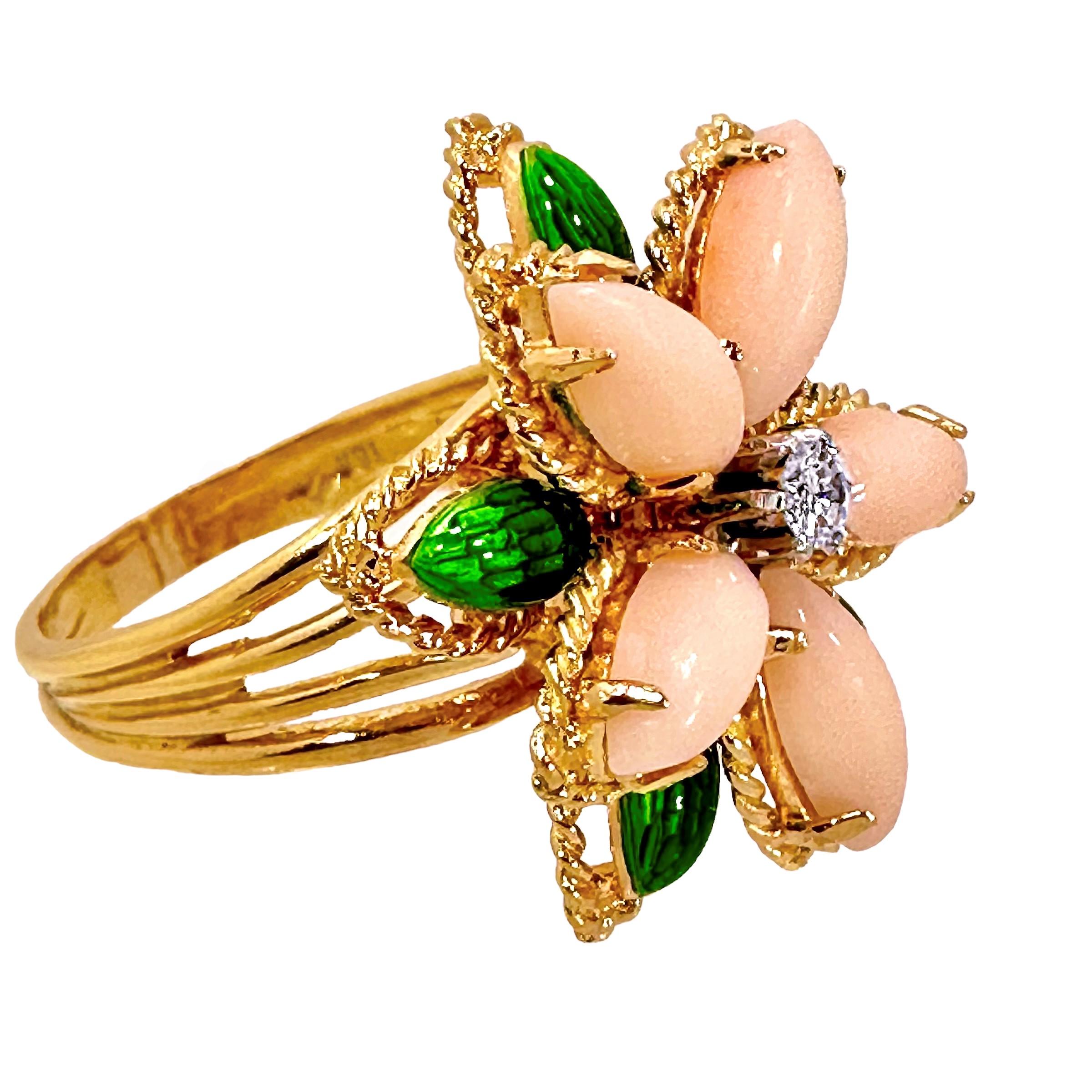 This lovely, Mid-20th Century 18K yellow gold Italian flower motif ring feels beautifully organic. The diamond in the center is surrounded by angel skin coral petals and transparent green enamel leaves. The diamond weighs approximately .17ct of G