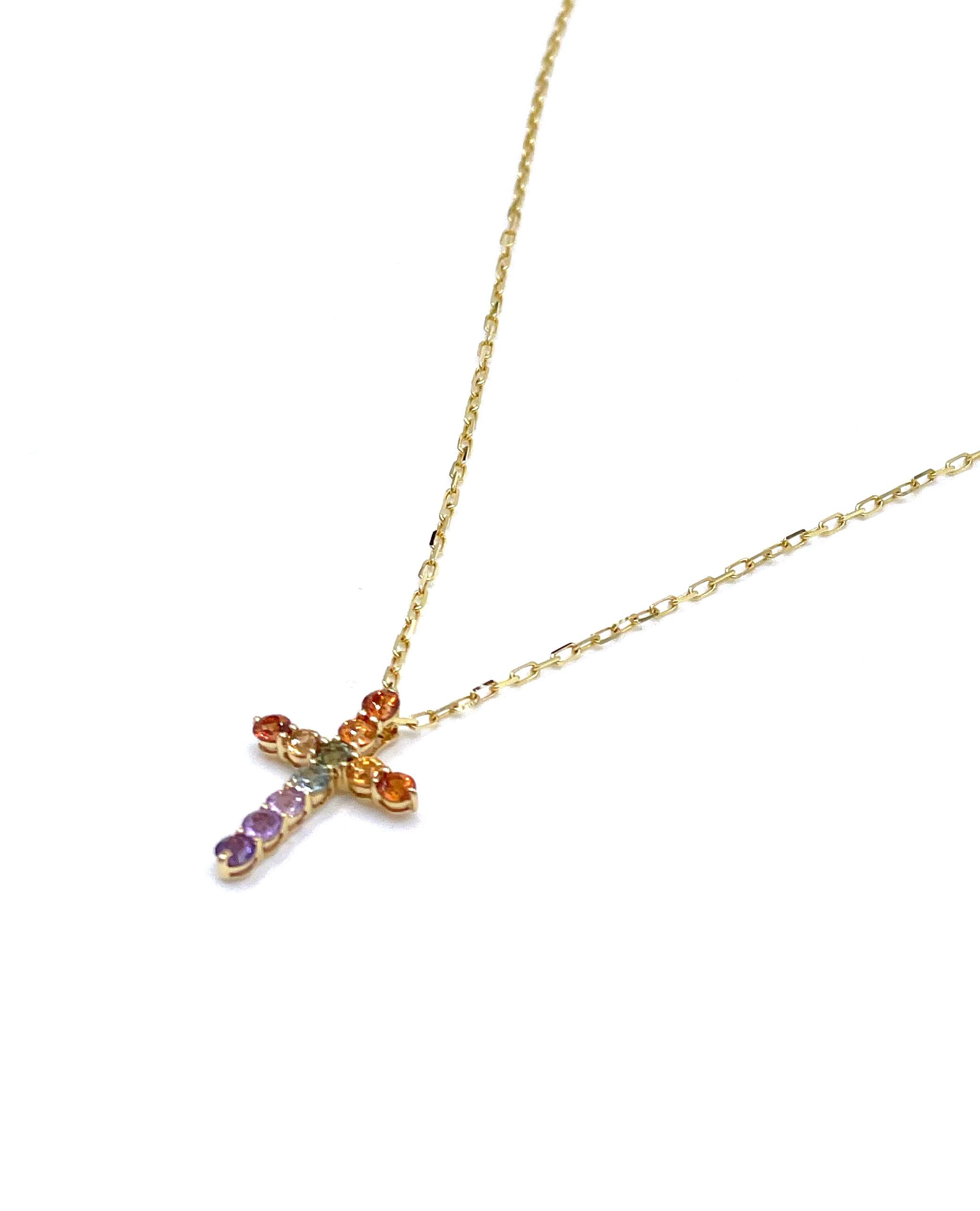 18K yellow gold cross necklace with 0.78 carat rainbow colored sapphires.

* Can be worn 16 or 18 inches long.
* Lobster lock closure.