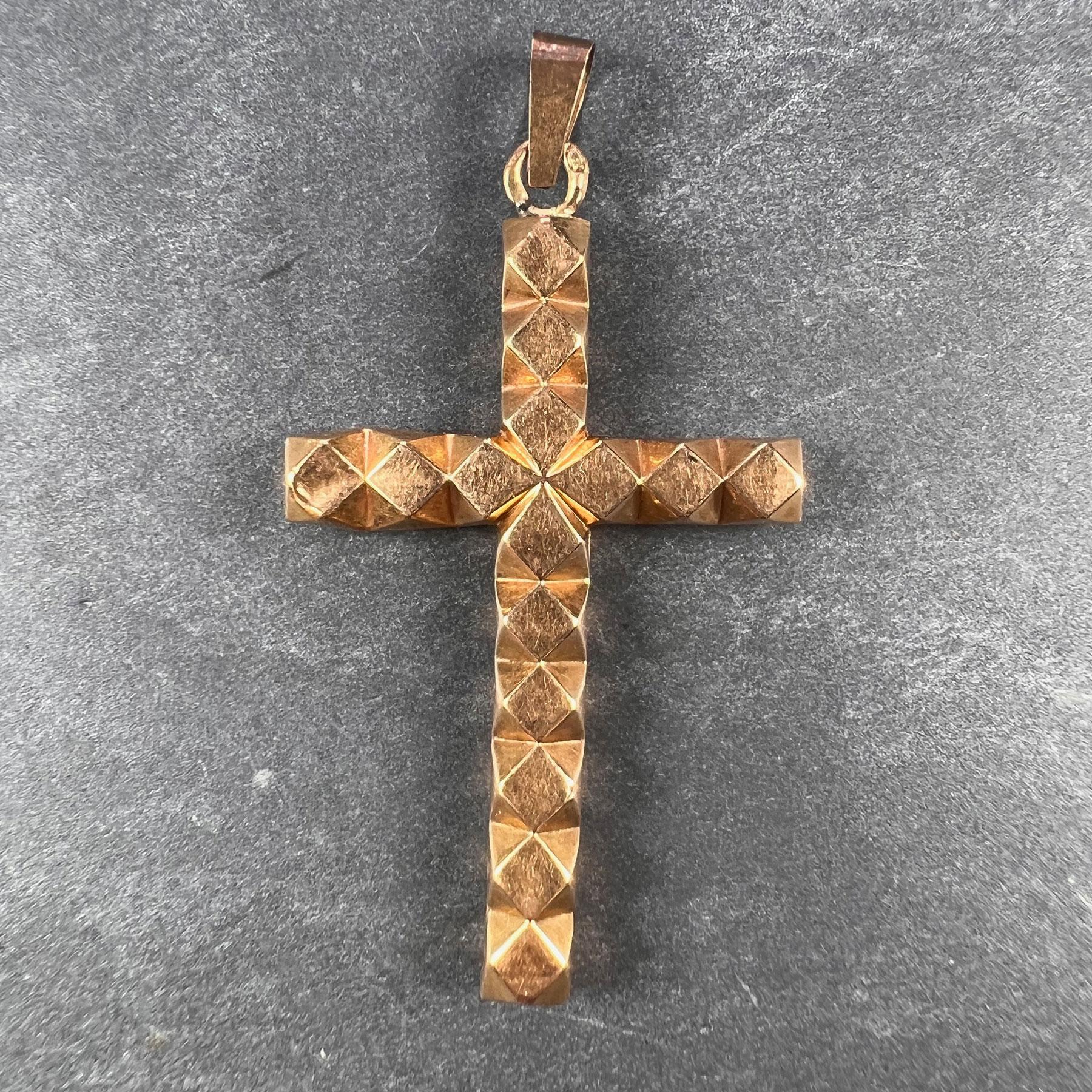 A 18 karat (18K) yellow gold pendant designed as a cross with diamond shapes throughout. Stamped with the owl mark for 18 karat gold and French import.

Dimensions: 3.7 x 2.2 x 0.35 cm (not including jump ring)
Weight: 0.90 grams 
(Chain not