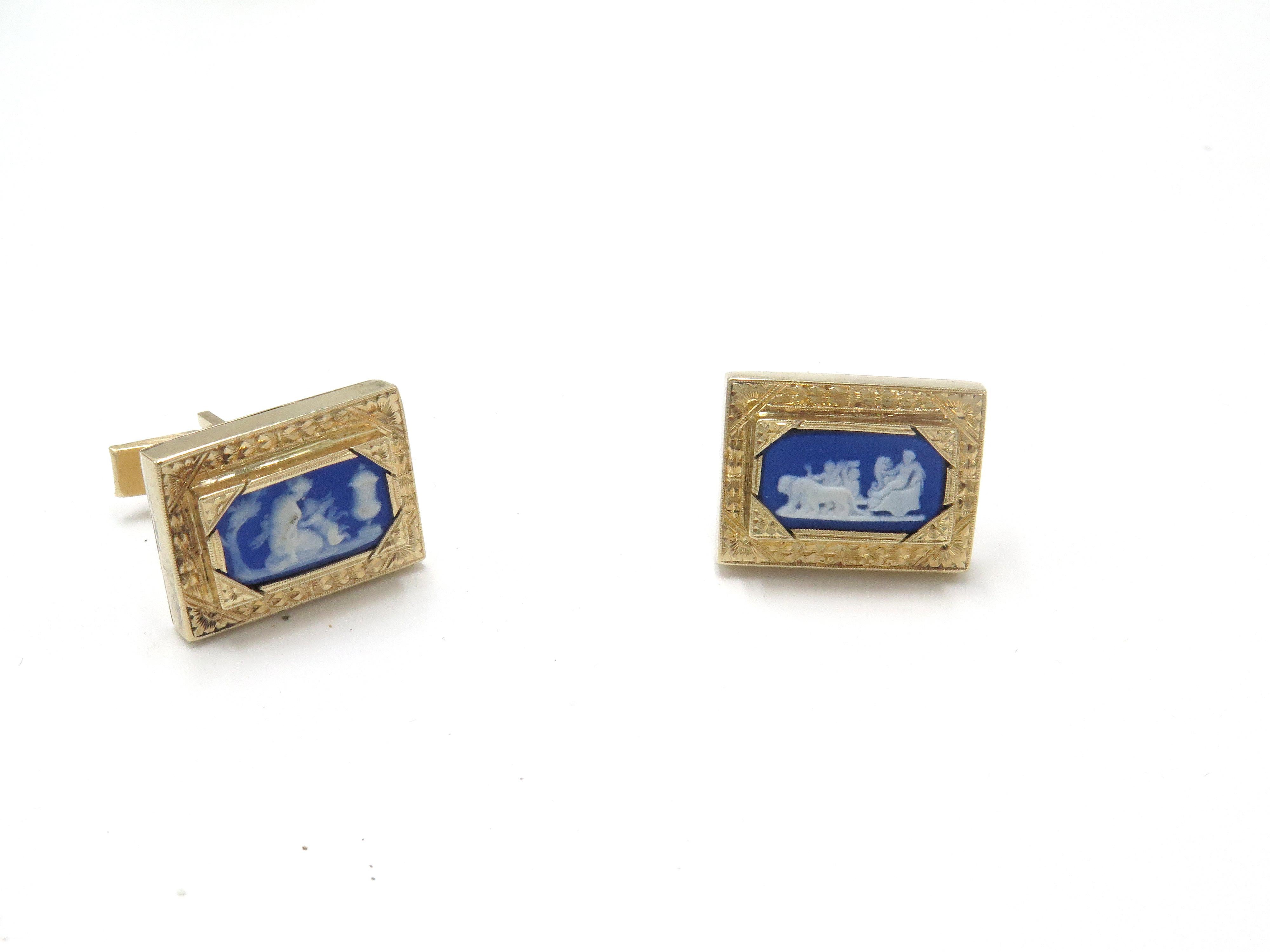A, beautiful pair of 18k yellow gold cuff links.  These, beautiful cufflinks feature a beautiful carved design in the center. These, beautiful cufflinks feature two unique drawings behind a blue enamel setting the border are are includes a frame