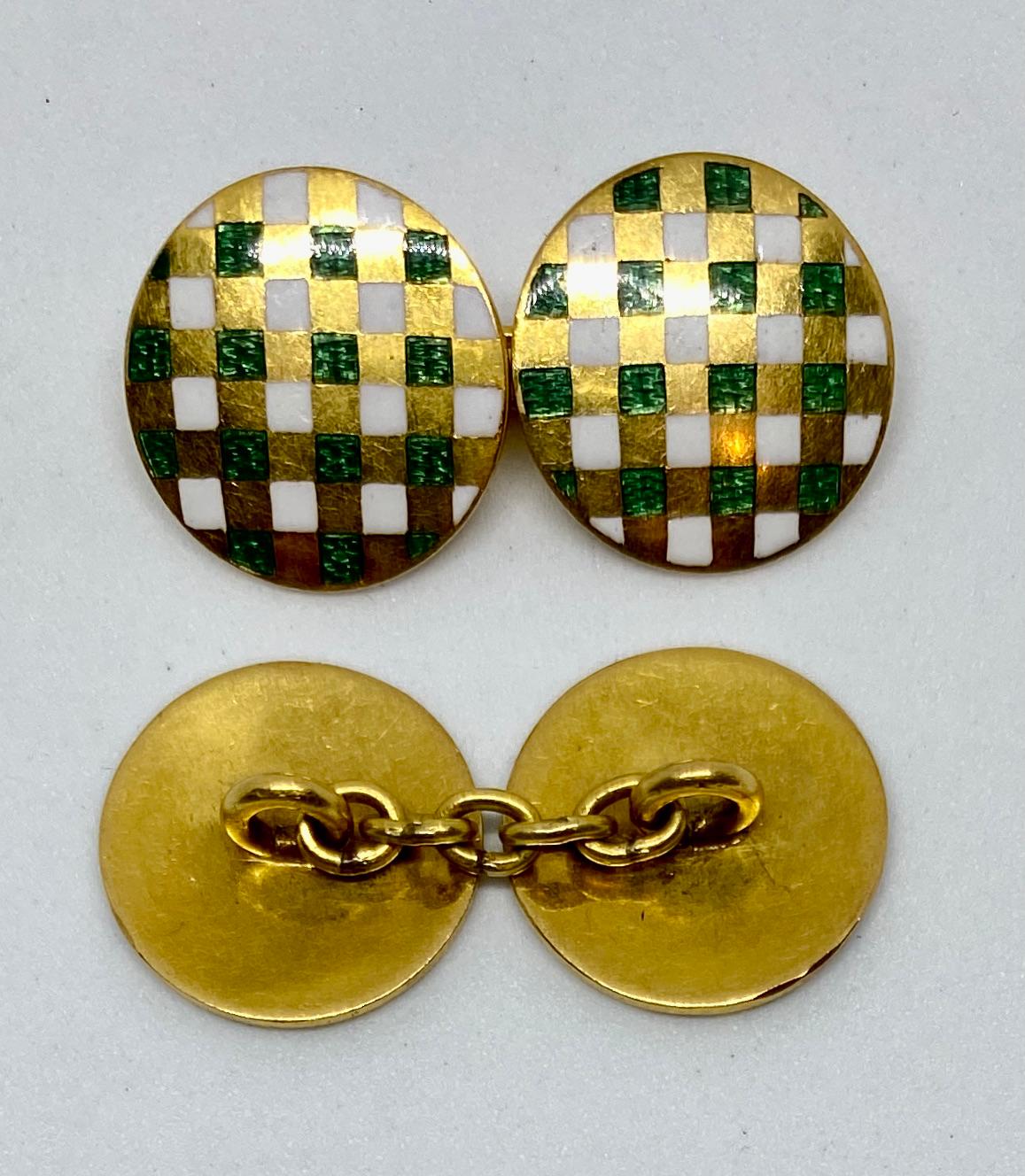 Beautiful, double-sided cufflinks in solid 18K yellow gold featuring opaque white and translucent green enameling in a checkered pattern. 

Each of the four faces measures 14.5mm in diameter and is connected to its mate by a yellow gold chain.