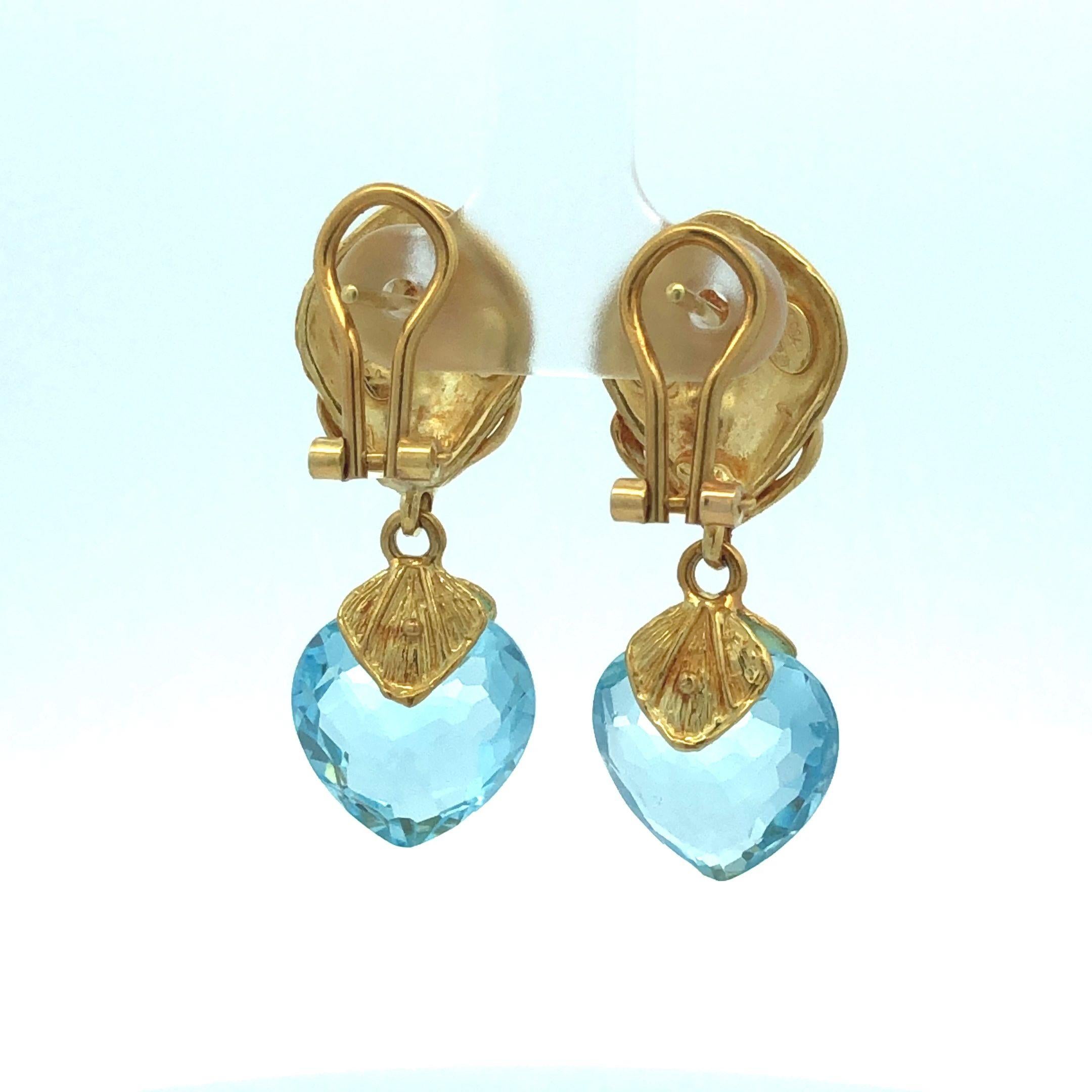 These earrings embody timeless elegance, exhibiting the exquisite brilliance of the blue topaz and the captivating allure of 18 karat yellow gold.

The focal point of these earrings is the heart-shaped briolette cuts of Blue Topaz, their facets